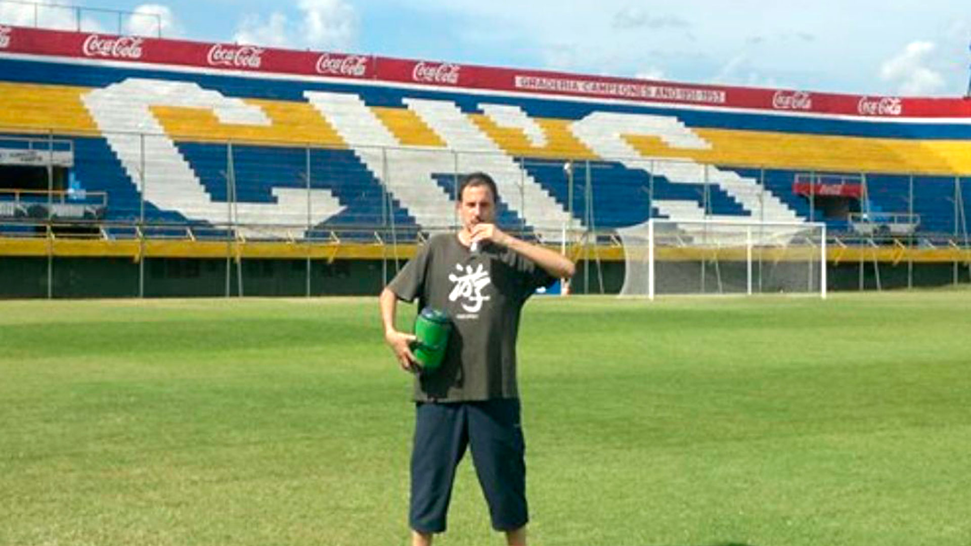 The author drinking tereré on the field of Sportivo Luqueño, Paraguay
