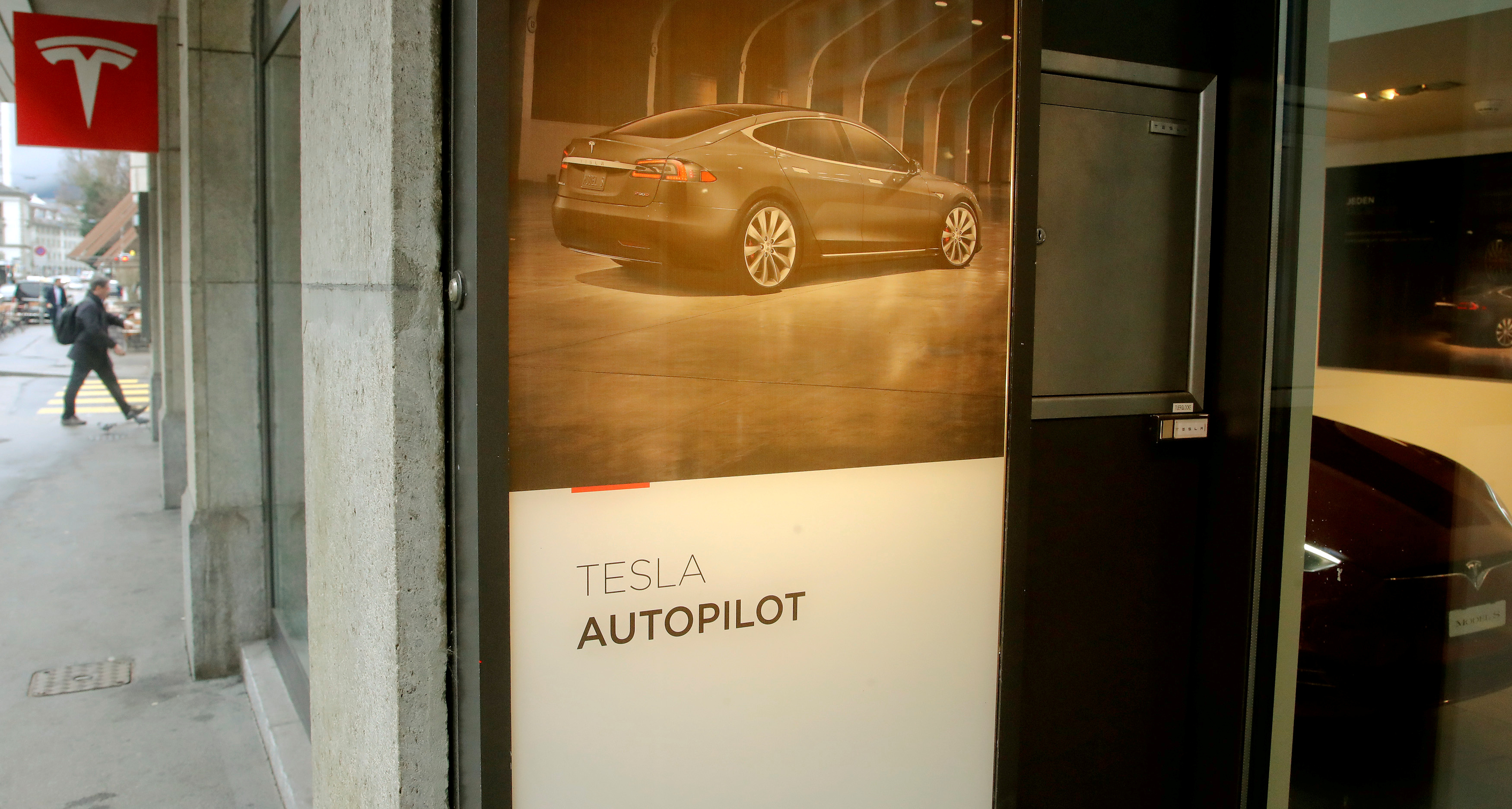 FILE PHOTO: An advertisement promotes Tesla Autopilot at a showroom of U.S. car manufacturer Tesla in Zurich, Switzerland March 28, 2018. REUTERS/Arnd Wiegmann/File Photo