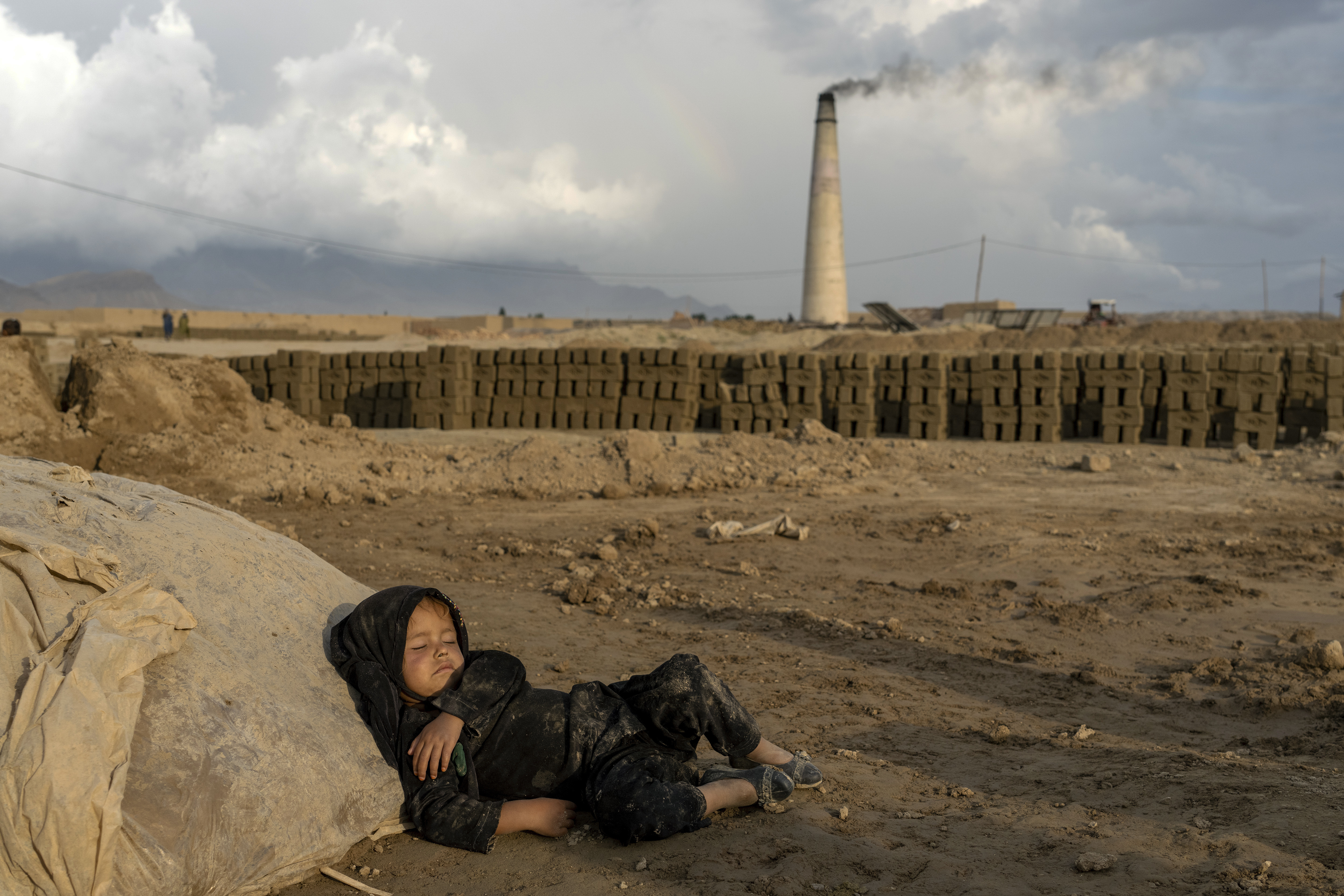 A 4-year-old Afghan girl sleeps after working at a brick factory on the outskirts of Kabul.