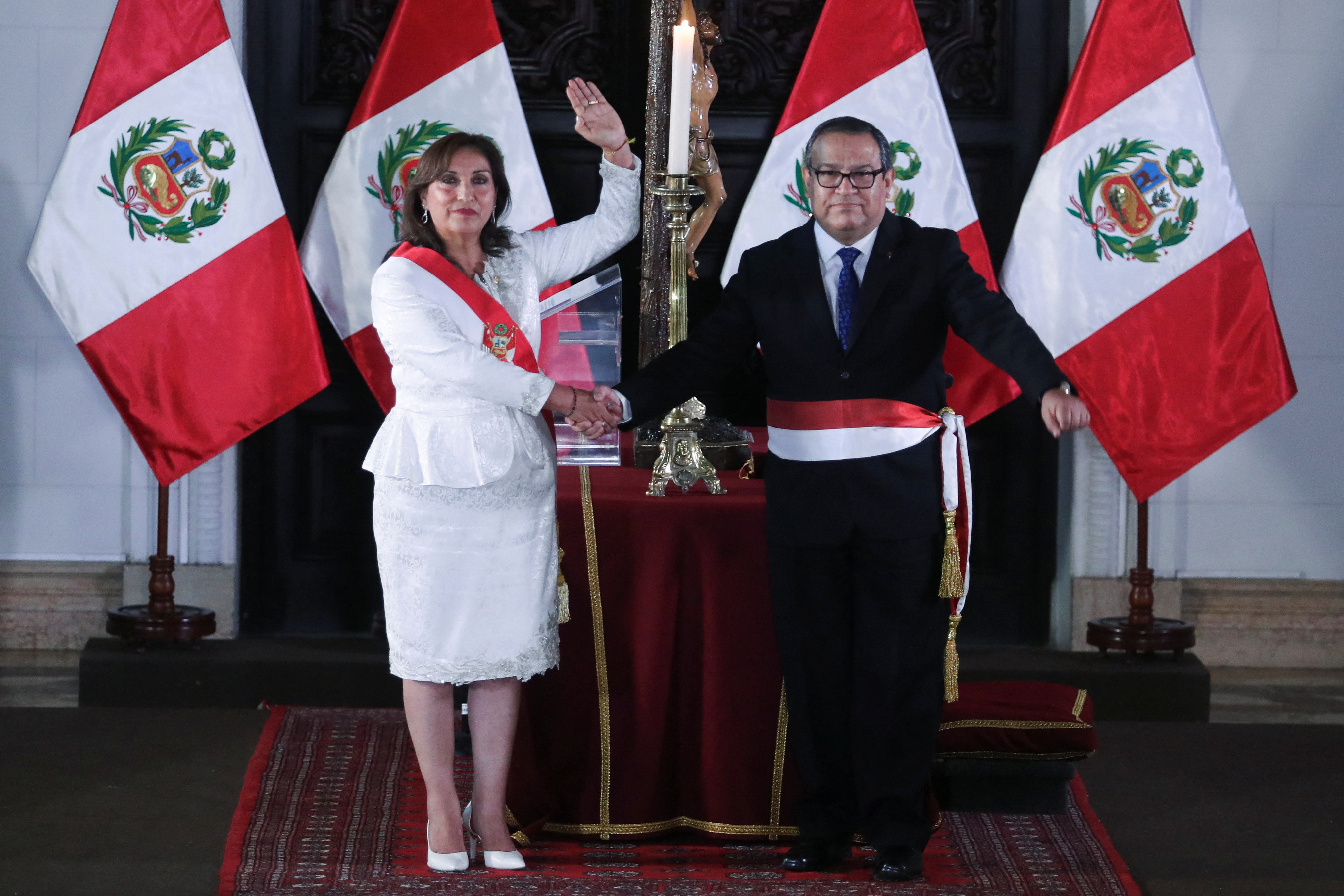 Peru's President Dina Boluarte, who took office after her predecessor Pedro Castillo was ousted, salutes next to Alberto Otarola, Minister of Defence, in Lima, Peru December 10, 2022. REUTERS/Sebastian Castaneda