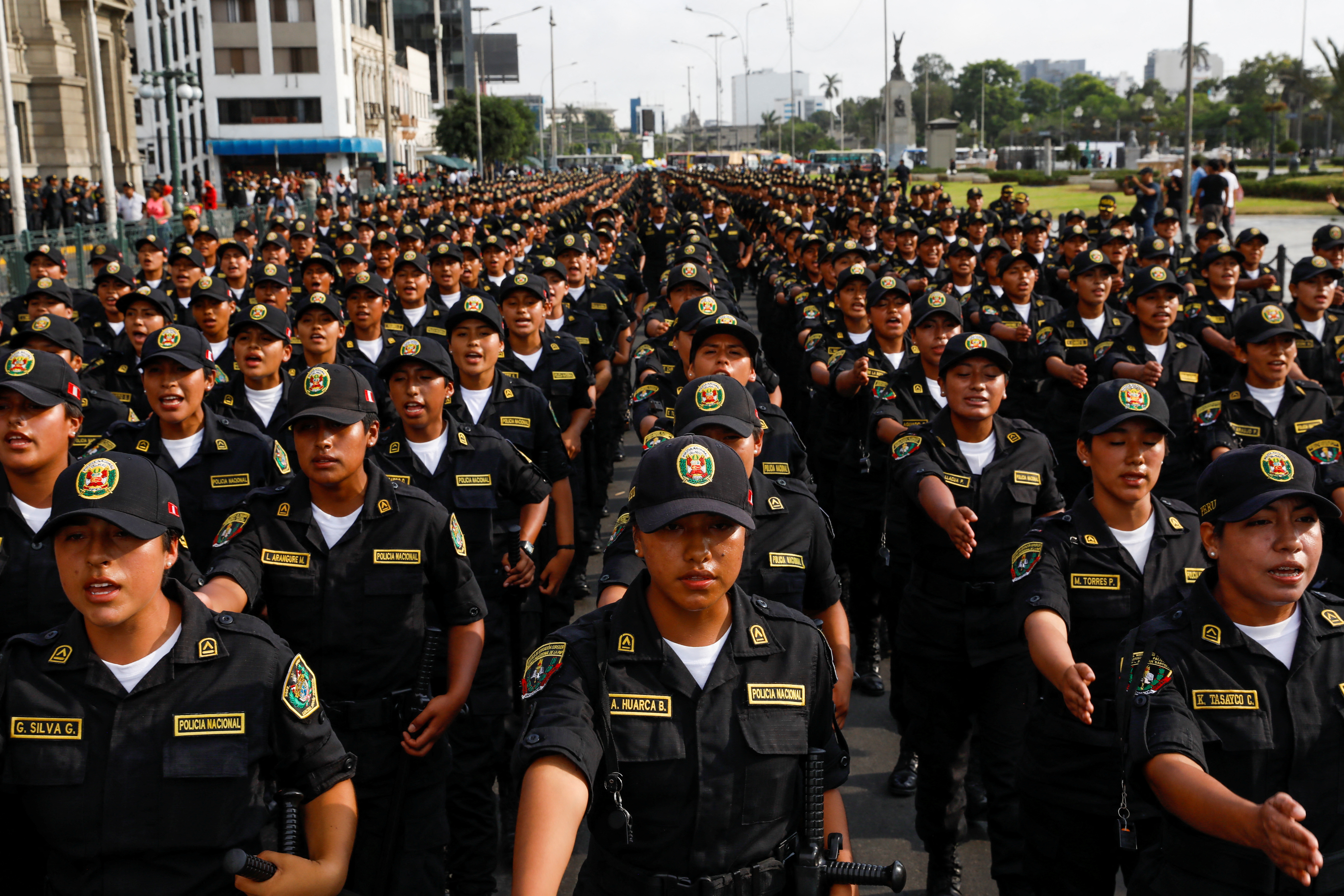 Police officers march while protesters call for an indefinite national strike in Lima. (REUTERS/Alessandro Cinque)