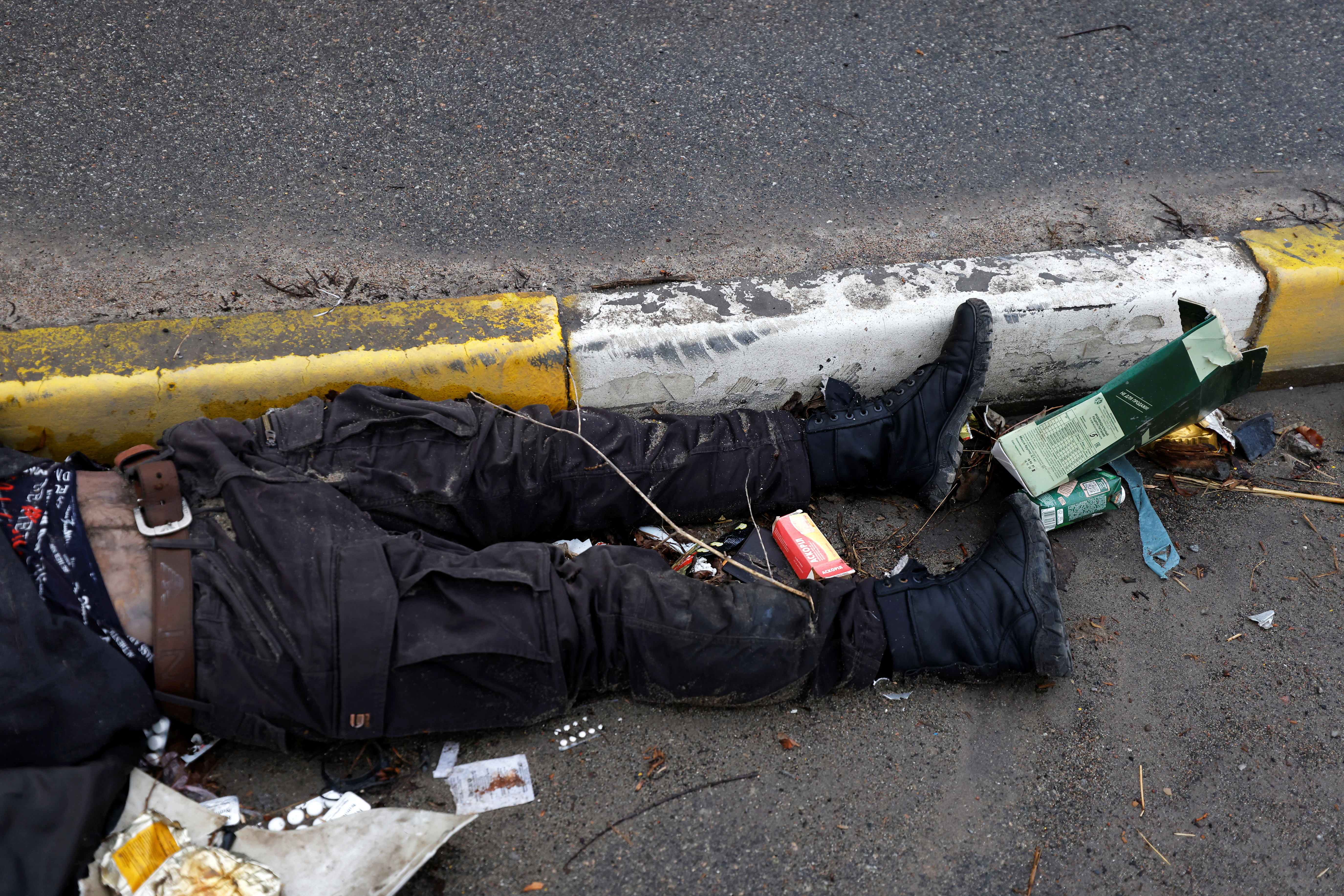 SENSITIVE MATERIAL. THIS IMAGE MAY OFFEND OR DISTURB    A body of a civilian, who according to residents was killed by Russian army soldiers, lies on the street, amid Russia's invasion of Ukraine, in Bucha, in Kyiv region, Ukraine April 2, 2022. REUTERS/Zohra Bensemra