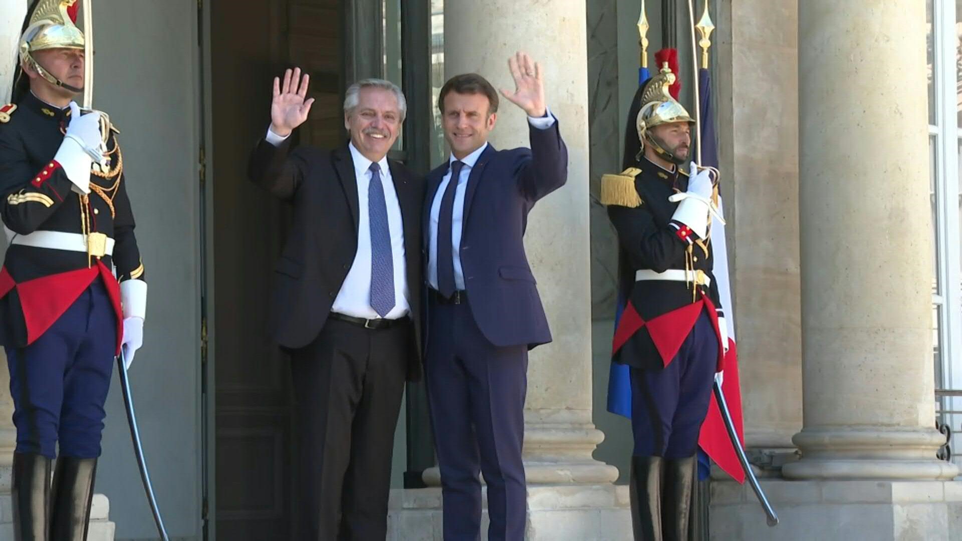 Alberto Fernández and Emmanuel Macron greet each other at the Eliseo Palace entrance, before their meeting to analyze the global situation due to the war in Ukraine