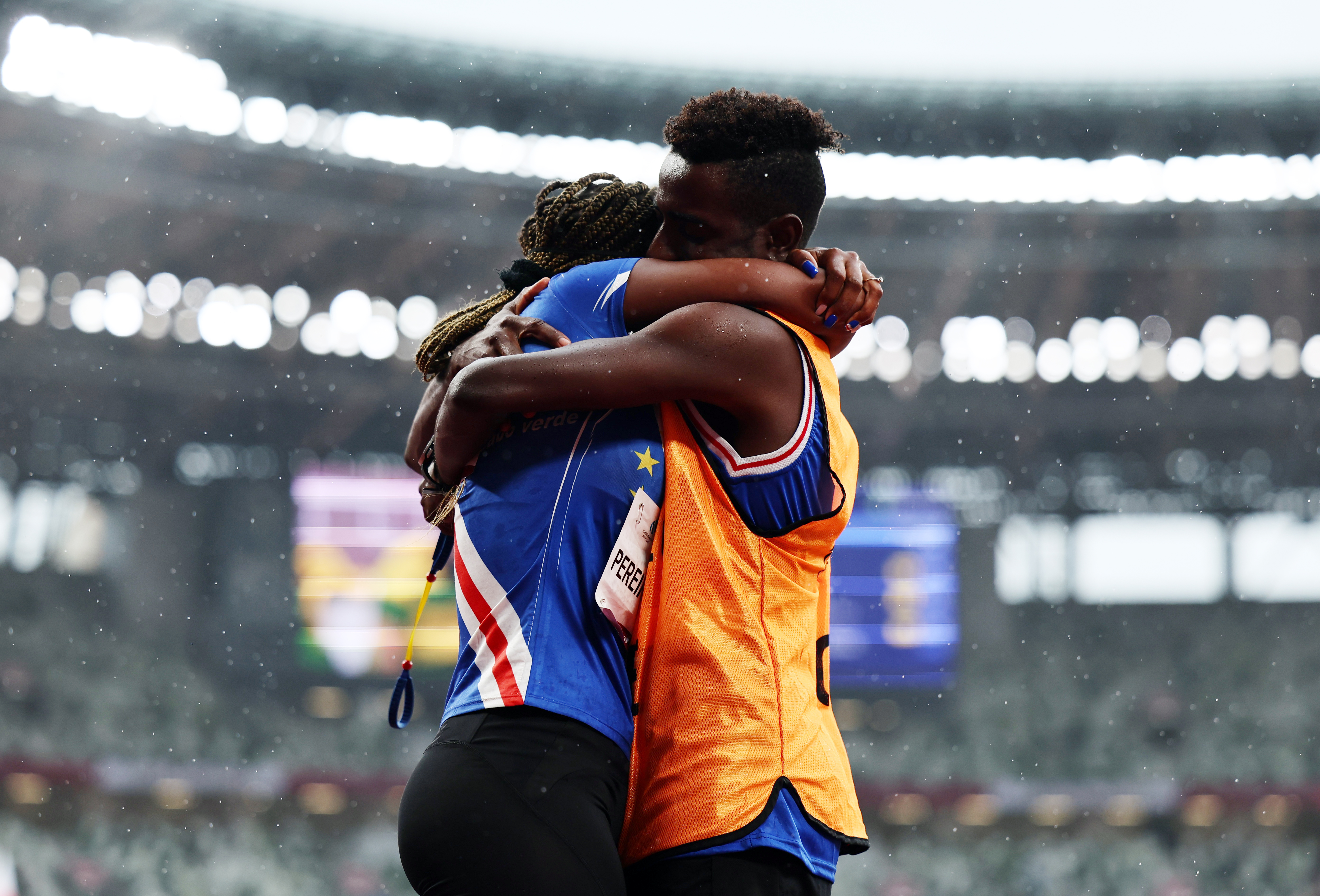 Tokyo 2020 Paralympic Games - Athletics - Women's 200m - T11 Round 1 - Heat 4 - Olympic Stadium, Tokyo, Japan - September 2, 2021. Keula Nidreia Pereira Semedo of Cape Verde and guide Manuel Antonio Vaz da Veiga embrace after he proposed to her after competing REUTERS/Athit Perawongmetha