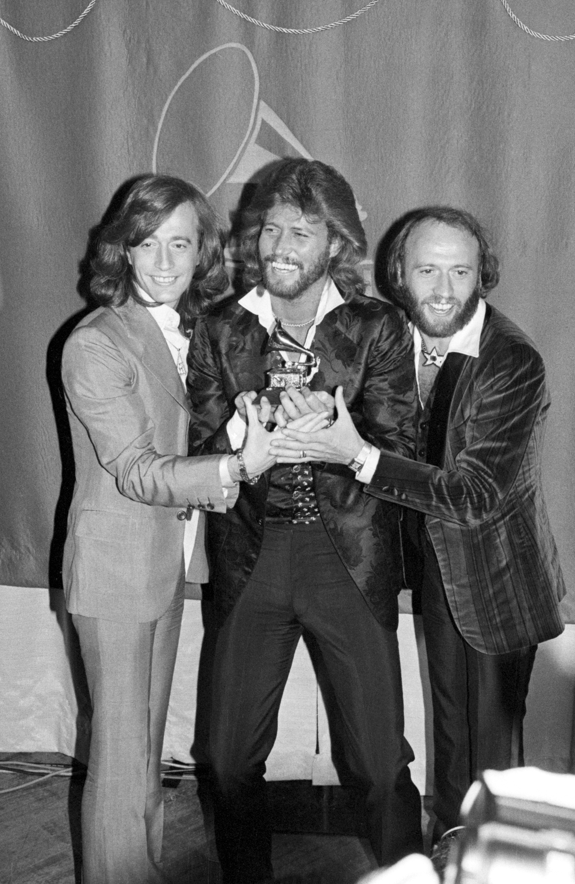 (Original Caption) Los Bee Gees con uno de los Grammy que obtuvieron por Saturday Night Fever. Cuando parecía que ya no tendrían éxito, a partir de 1975, una vez más, le dieron una vuelta a su carrera