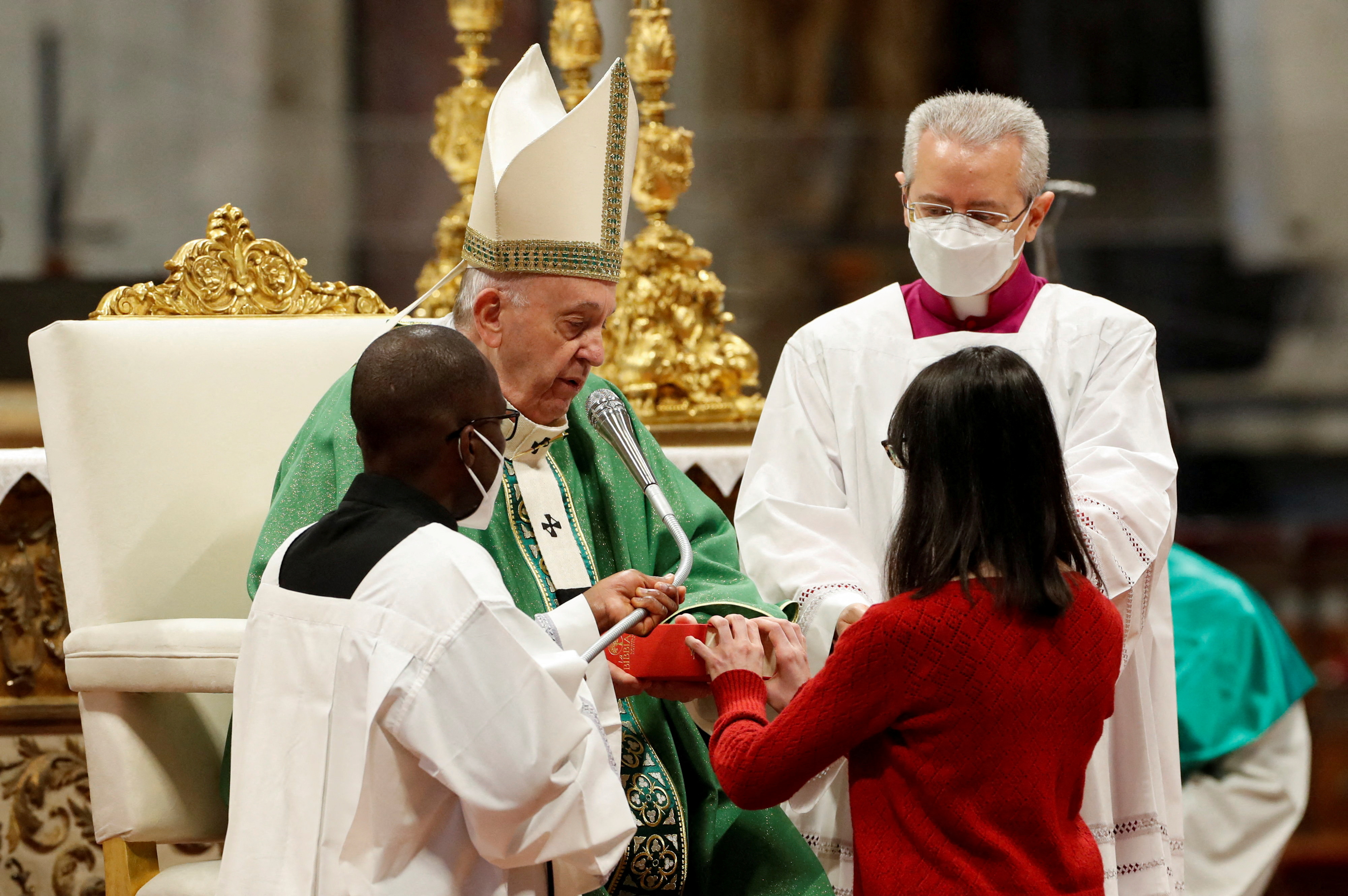 Una lectoar recibe un evangelio de manos del Papa Francisco durante la Santa Misa en la Basílica de San Pedro del Vaticano, el 23 de enero de 2022. REUTERS/Remo Casilli