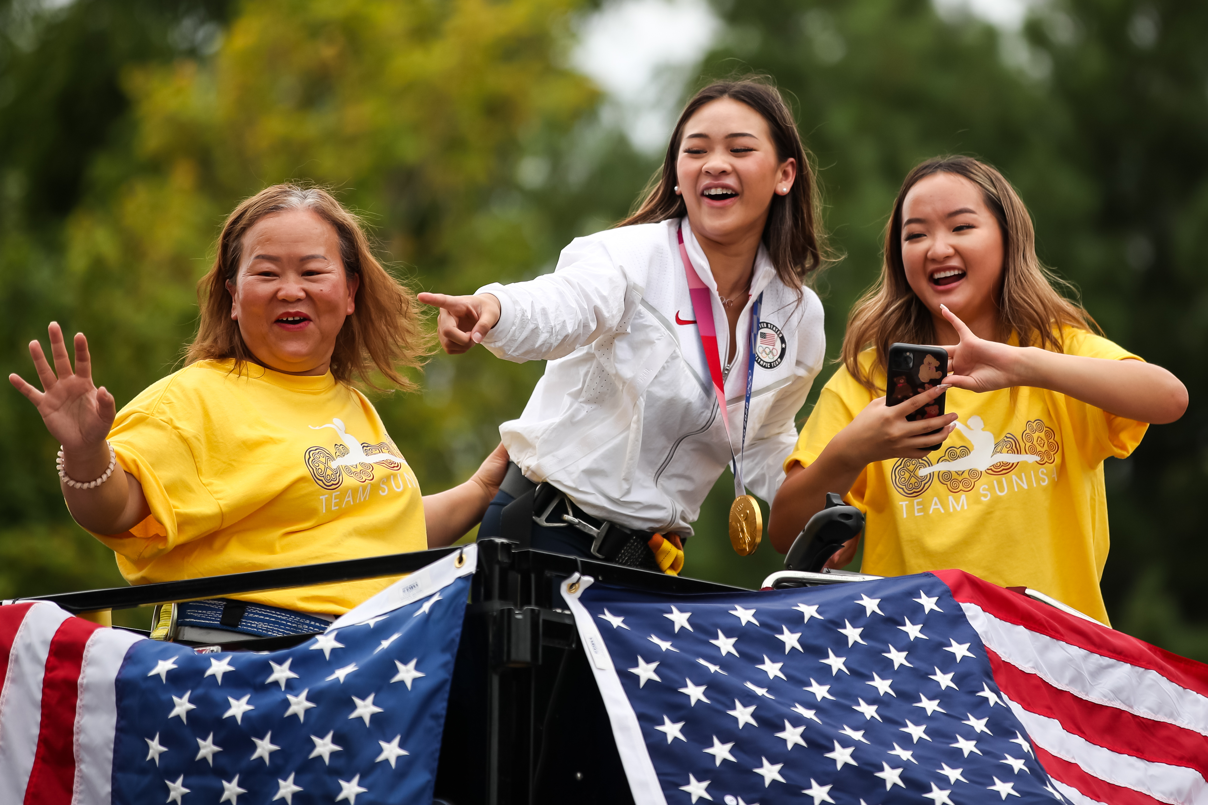 Aug 8, 2021; St. Paul, MN, USA; Olympic Gold Medalist Suni Lee reacts to fans during a parade. Mandatory Credit: David Berding-USA TODAY Sports