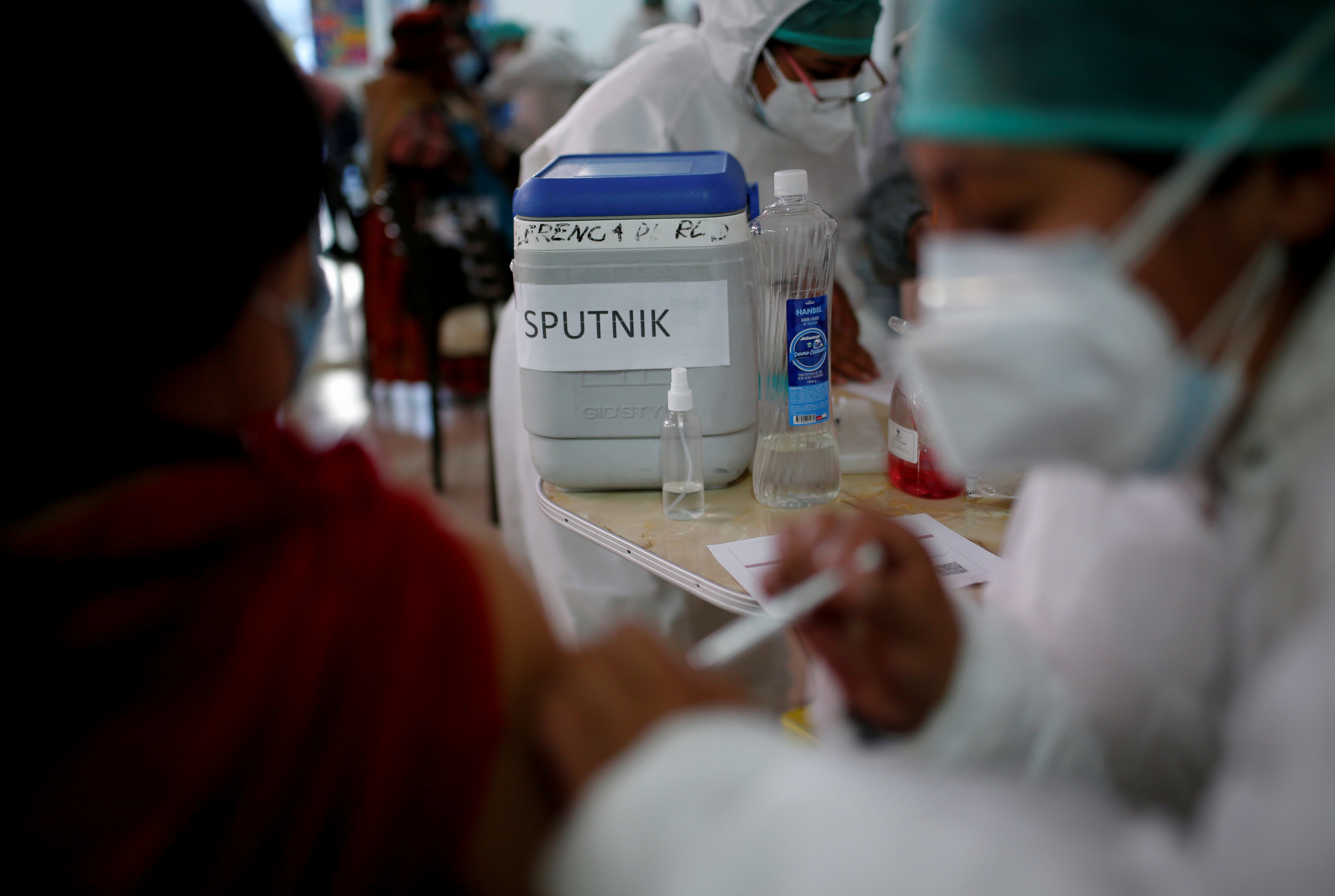 A person receives Russia's Sputnik V vaccine against the coronavirus disease (COVID-19) at a Mi Teleferico cable car station turned into a vaccination centre, in El Alto, Bolivia July 25, 2021. REUTERS/Manuel Claure