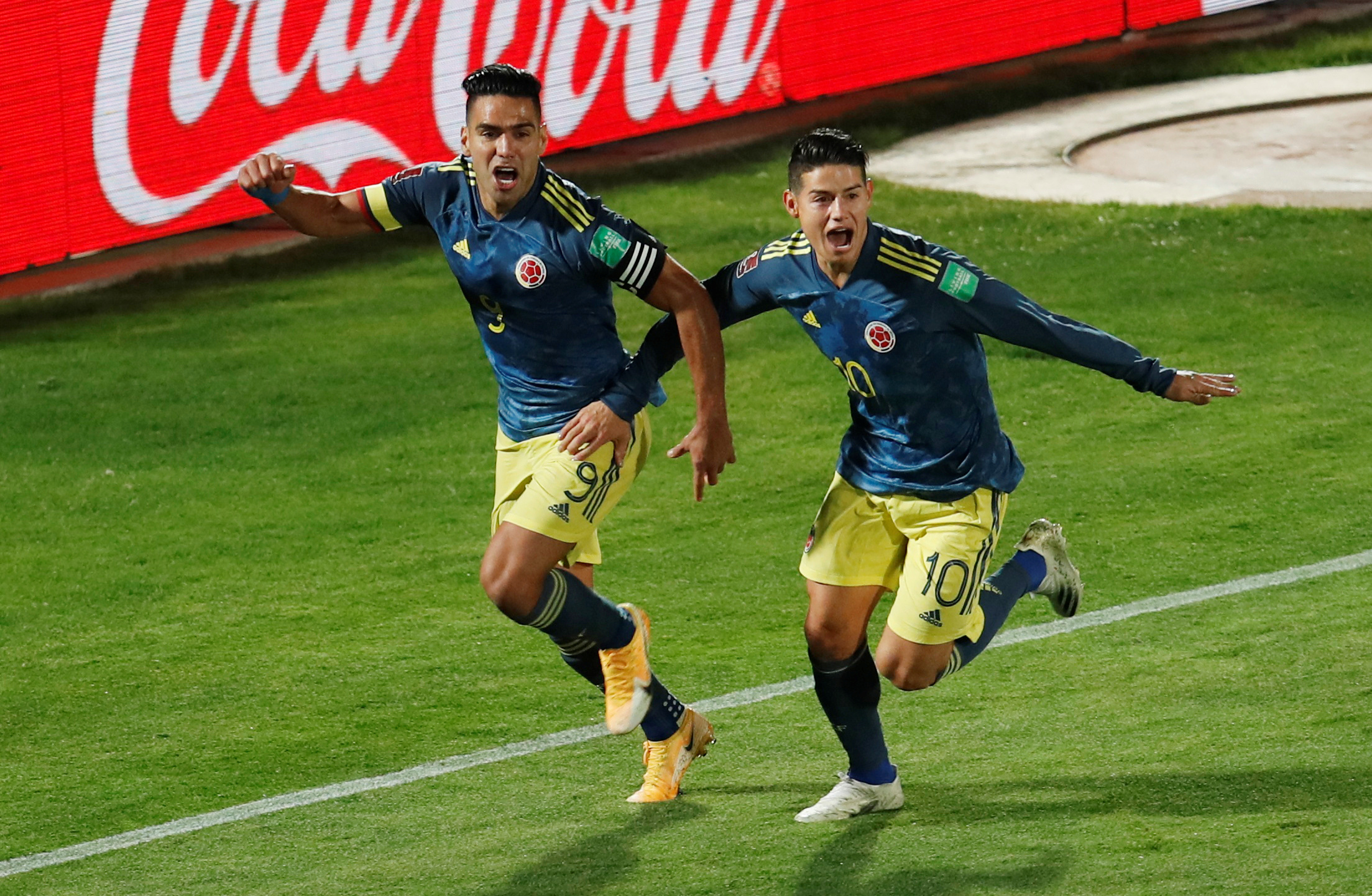 Soccer Football - World Cup 2022 South American Qualifiers - Chile v Colombia - Estadio Nacional, Santiago, Chile - October 13, 2020  Colombia's Radamel Falcao celebrates scoring their second goal with James Rodriguez Alberto Valdes/Pool via REUTERS