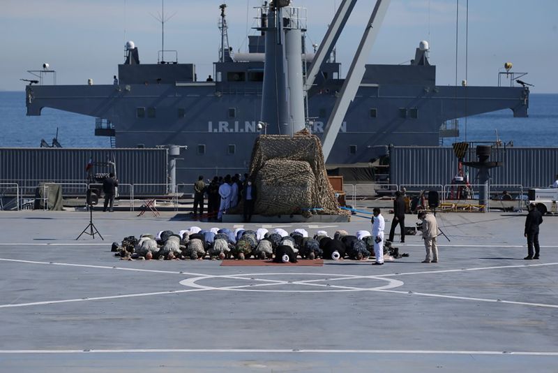 File photo of Iranian military commander and other members of the armed forces praying on the Iranian-made Makran warship during an exercise in the Gulf of Oman.  January 13, 2021. Iranian Army/WANA (West Asia News Agency)/Handout via REUTERS