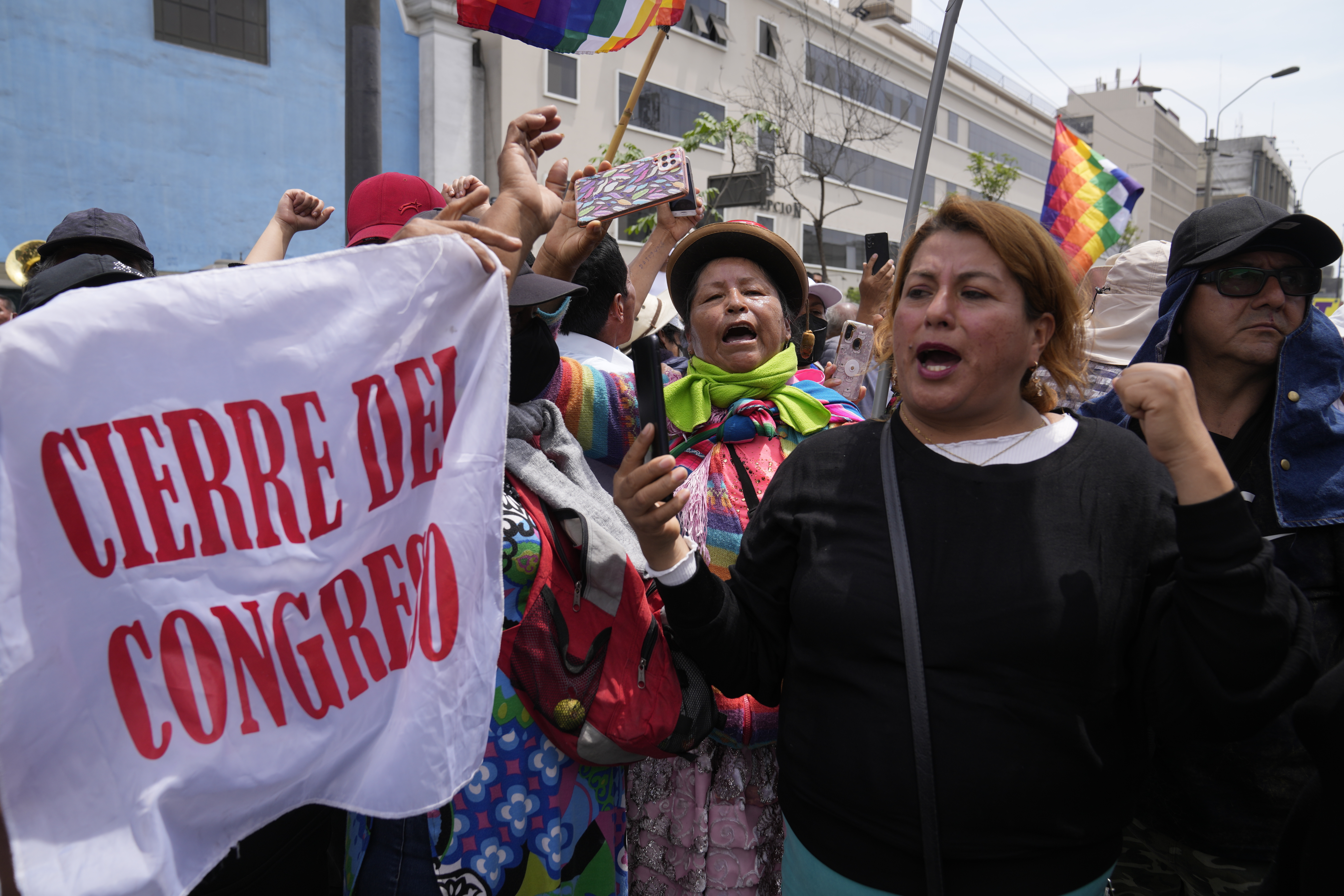 Seguidores del presidente peruano Pedro Castillo protestan portando una bandera que dice "cierre del Congreso" el día en que estaba prevista una sesión para destituir al presidente, cerca del Congreso en Lima, Perú, el miércoles 7 de diciembre. Castillo disolvió el Congreso el miércoles y convocó nuevas elecciones legislativas, antes de que los legisladores pudieran debatir el tercer intento de removerlo del cargo. (AP Foto/Martín Mejía)