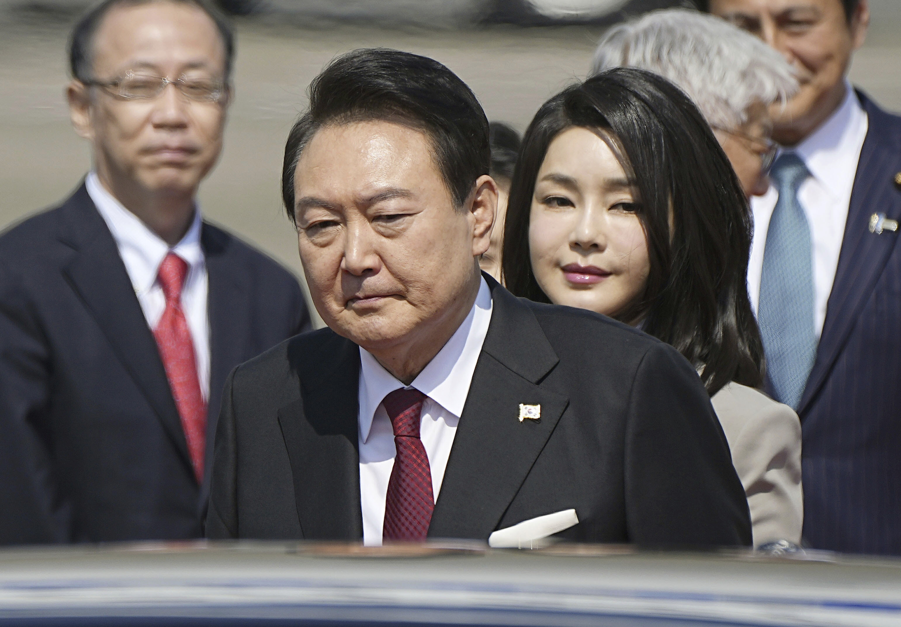 South Korean President Yoon Suk Yeol and his wife Kim Keon Hee arrive at Tokyo's Haneda International Airport, Thursday, March 16, 2023. Yoon and Japan's Prime Minister Fumio Kishida try to settle disputes milestones and rebuild economic and security ties at their meeting on Thursday, the first summit between the two countries in more than a decade.  (Yuya Shino/Kyodo News via AP)