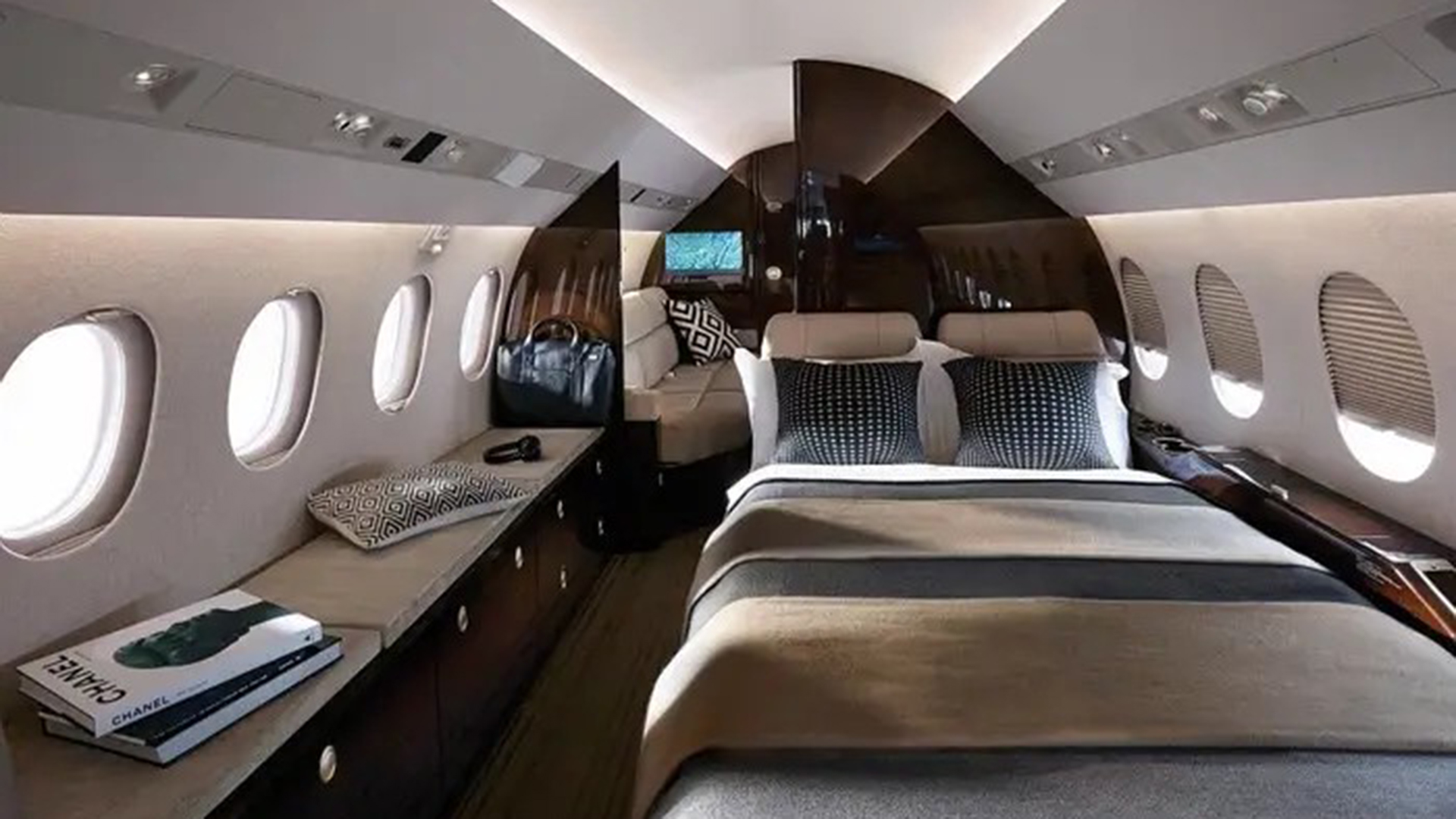 The Falcon 900 allows the rear to be configured as a private room for two people.  (https://www.dassault-aviation.com/)