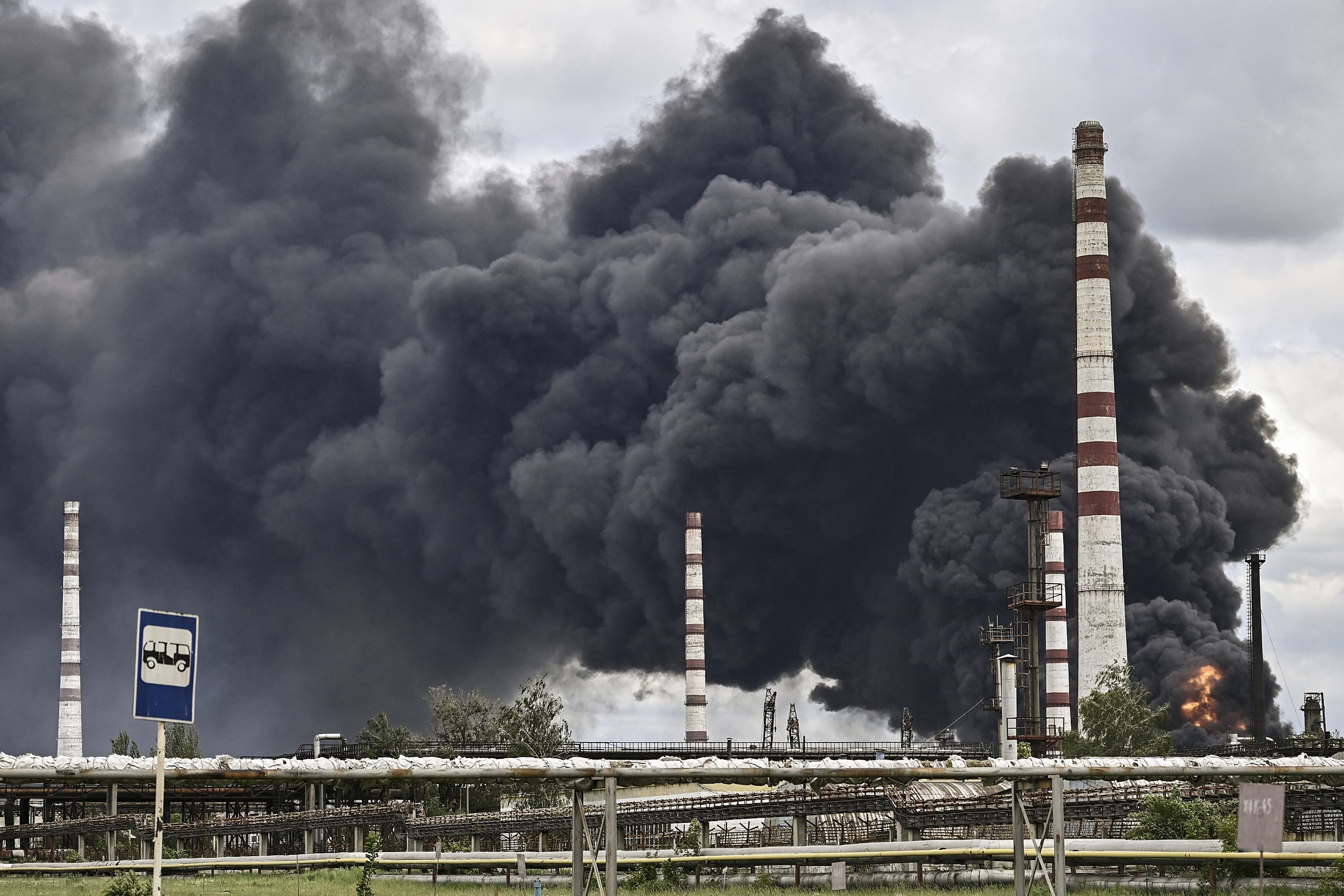 Smoke rises from an oil refinery after an attack outside the city of Lysychans in the eastern Donbass region, Ukraine, May 22, 2022. (AFP Photo)