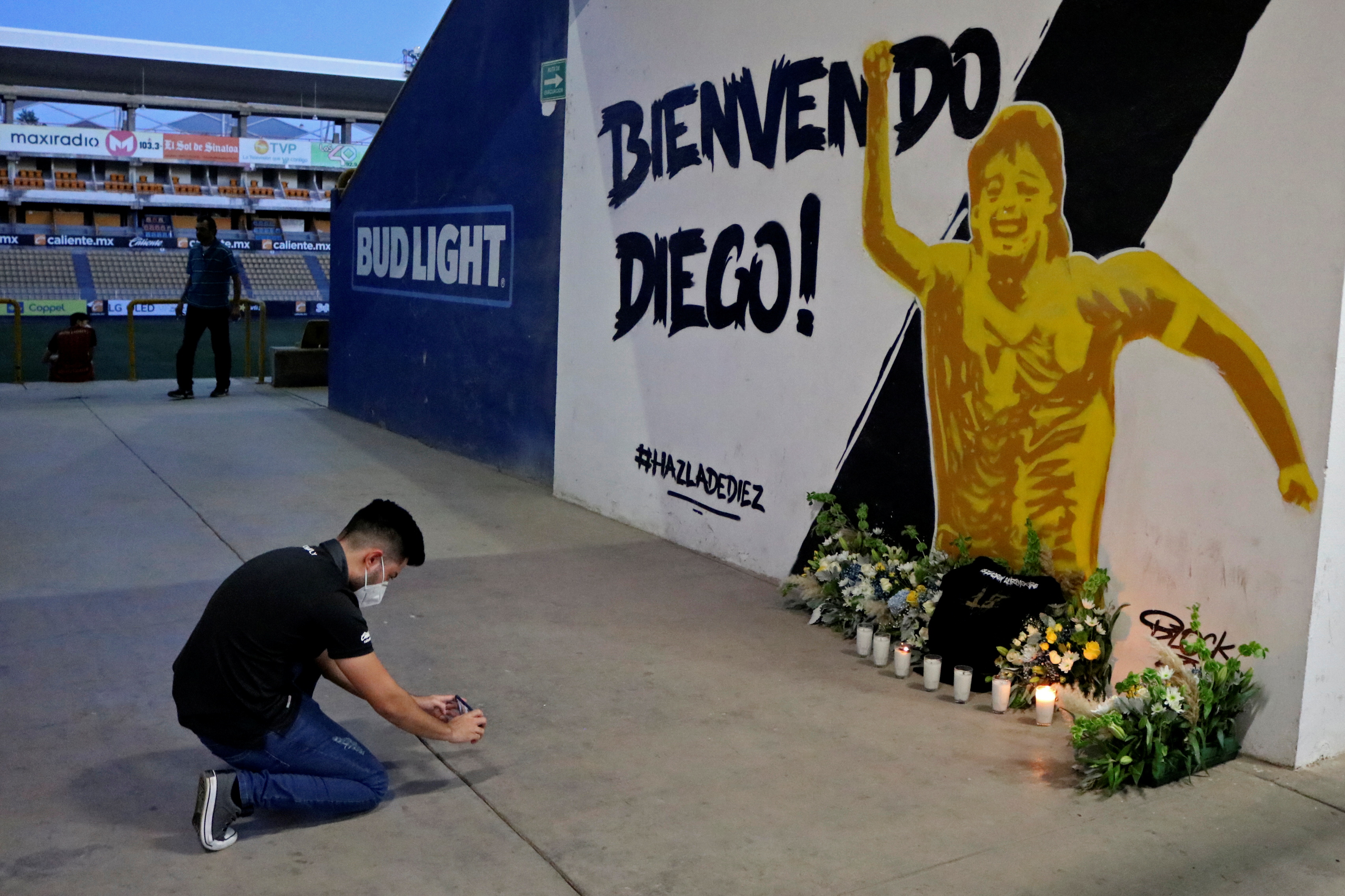 Un fanático toma una foto de un mural que muestra a la leyenda del fútbol argentino Diego Armando Maradona, quien fue el entrenador del equipo, en el estadio Dorados en Culiacán, estado de Sinaloa, México, 25 de noviembre de 2020.