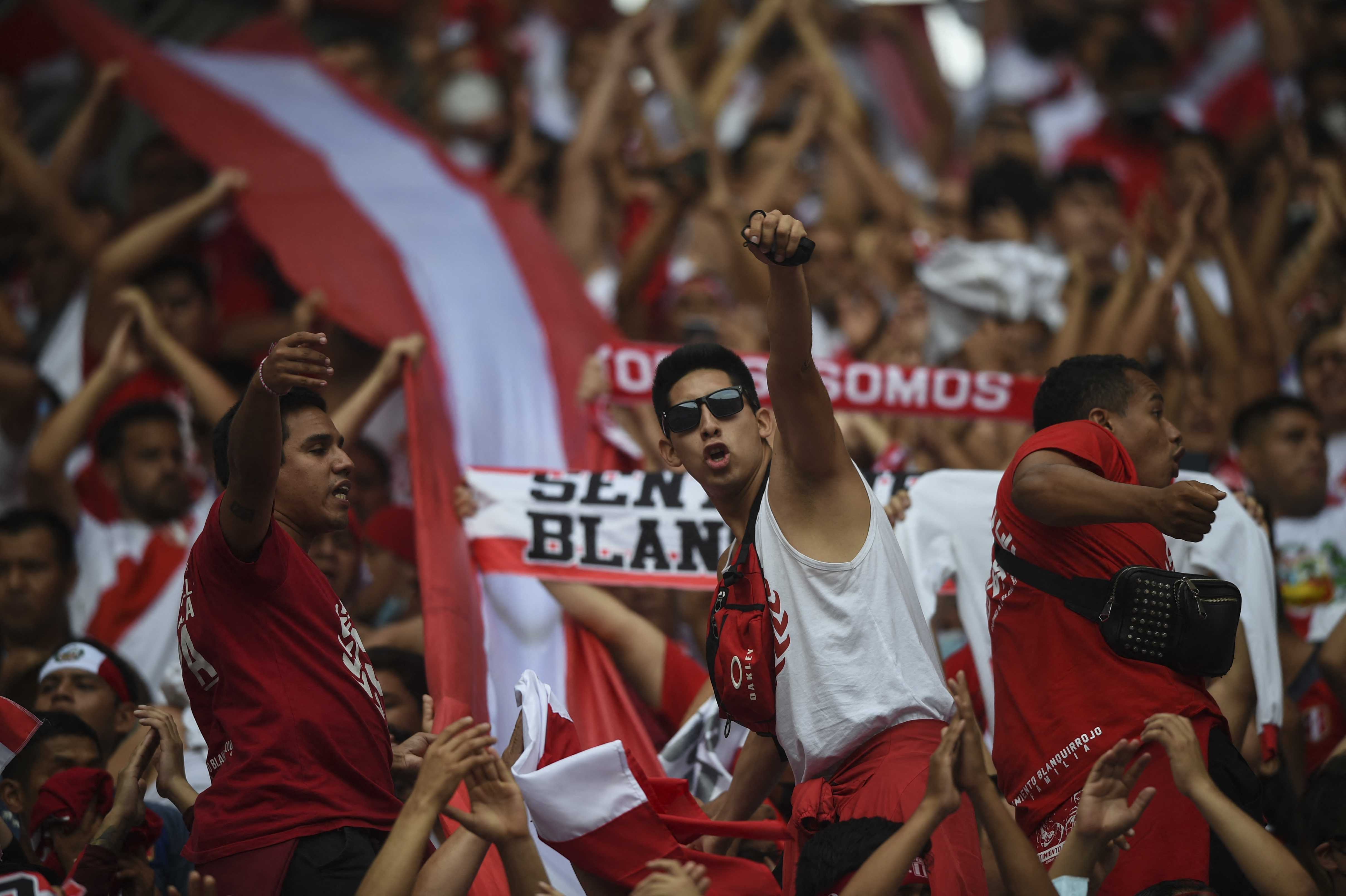 Fans of Peru cheer before the start of the South American qualification football match for the FIFA World Cup Qatar 2022 against Paraguay, at the National Stadium in Lima on March 29, 2022. (Photo by ERNESTO BENAVIDES / AFP)