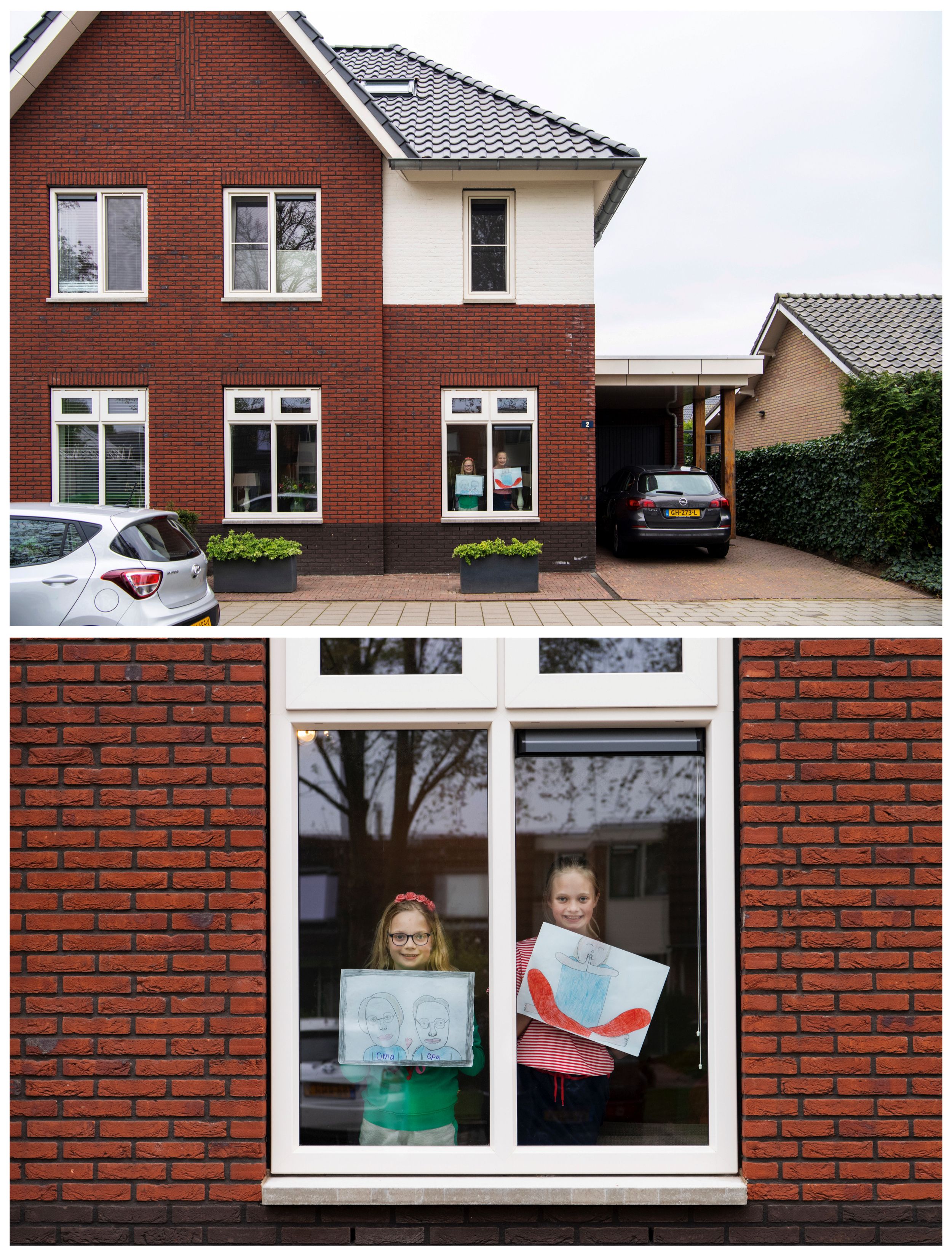 En las imágenes se ve a Noalynne te Selle, 9, y Annelou te Selle, 10, posando para una foto mientras sostienen dibujos que hicieron durante el brote de coronavirus, paradas sobre una ventana dentro de su casa en Lent, Holanda, el 18 de abril de 2020. Noalynne dijo: