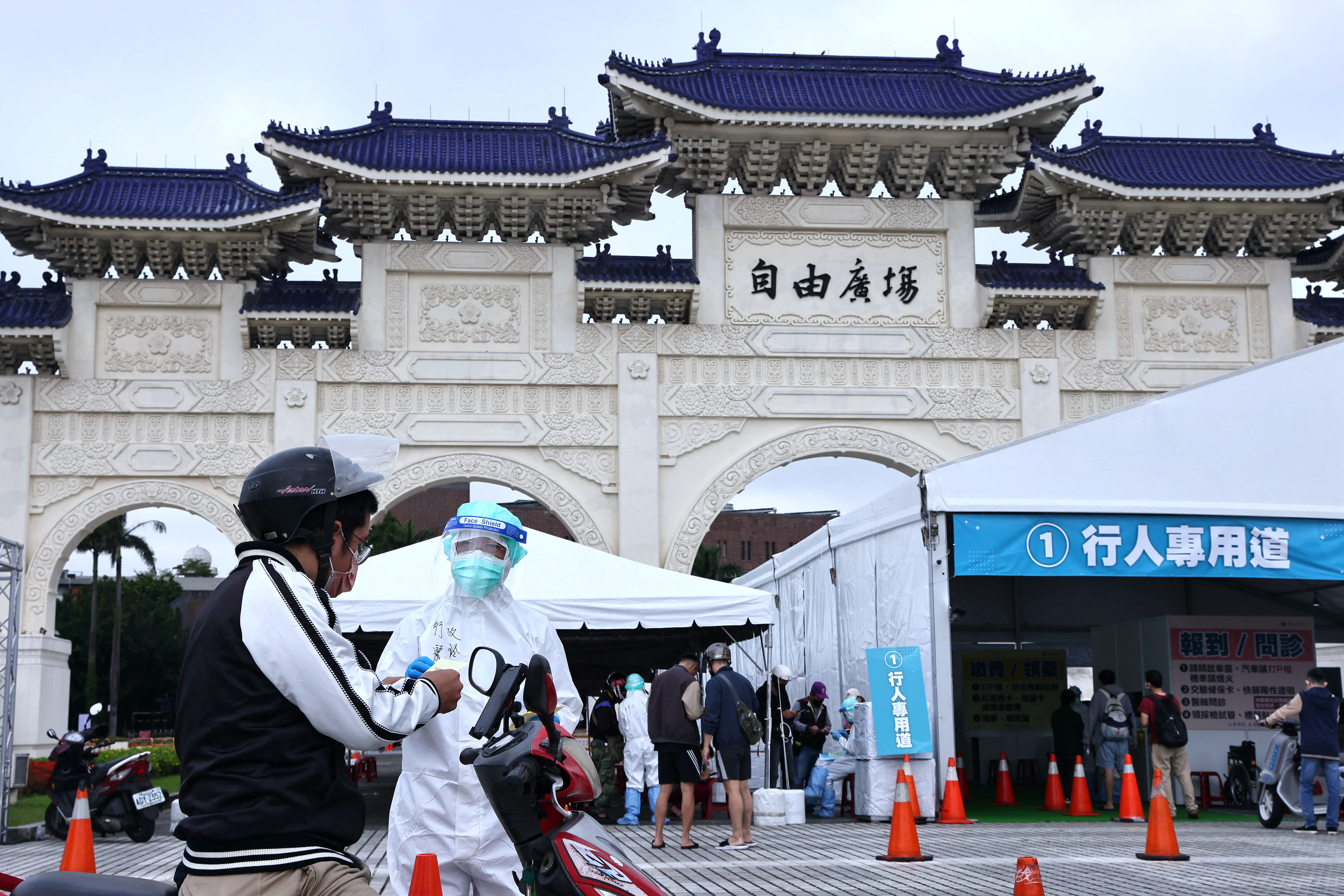 People line up to get a coronavirus disease (COVID-19) test at a newly set up drive-through site at Liberty Square in Taipei