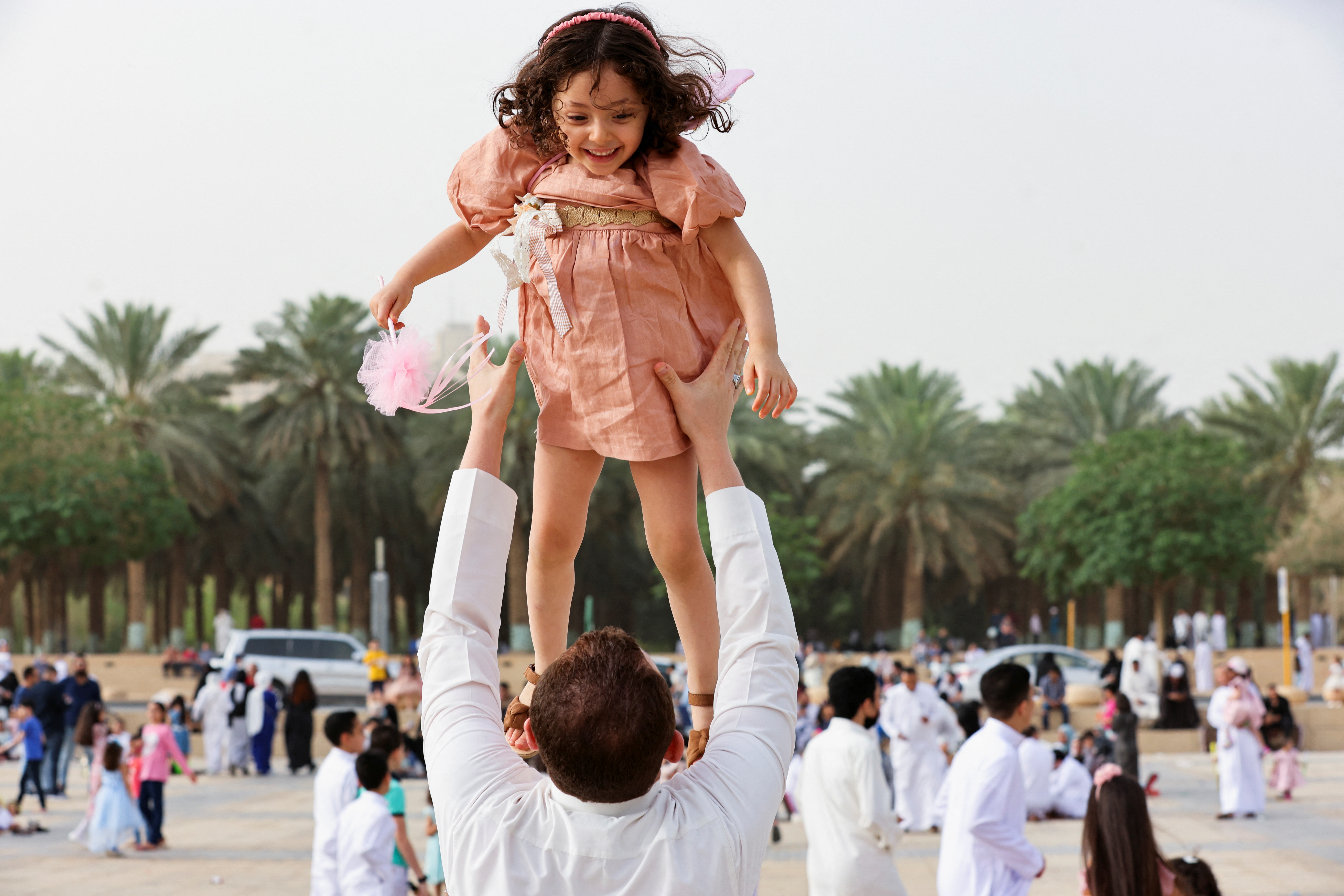 A Saudi man holds his daughter during Eid al-Fitr celebration at the King Abdul Aziz Mosque, in Riyadh, Saudi Arabia, May 2, 2022. REUTERS/Ahmed Yosri