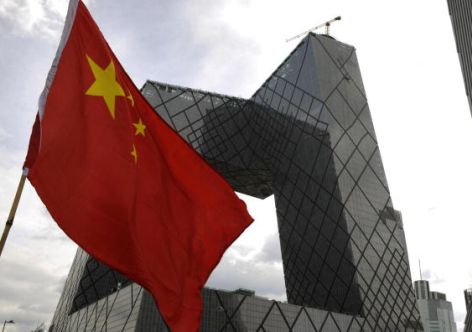 Picture taken on August 1, 2008 in Beijing, where the Summer Olympic Games 2008 took place, shows a Chinese flag fluttering in front of the headquarters of the Central Chinese Television (CCTV), constructed by Dutch architect Rem Koolhaas.    AFP PHOTO    DDP/AXEL SCHMIDT (Photo credit should read AXEL SCHMIDT/AFP/Getty Images)