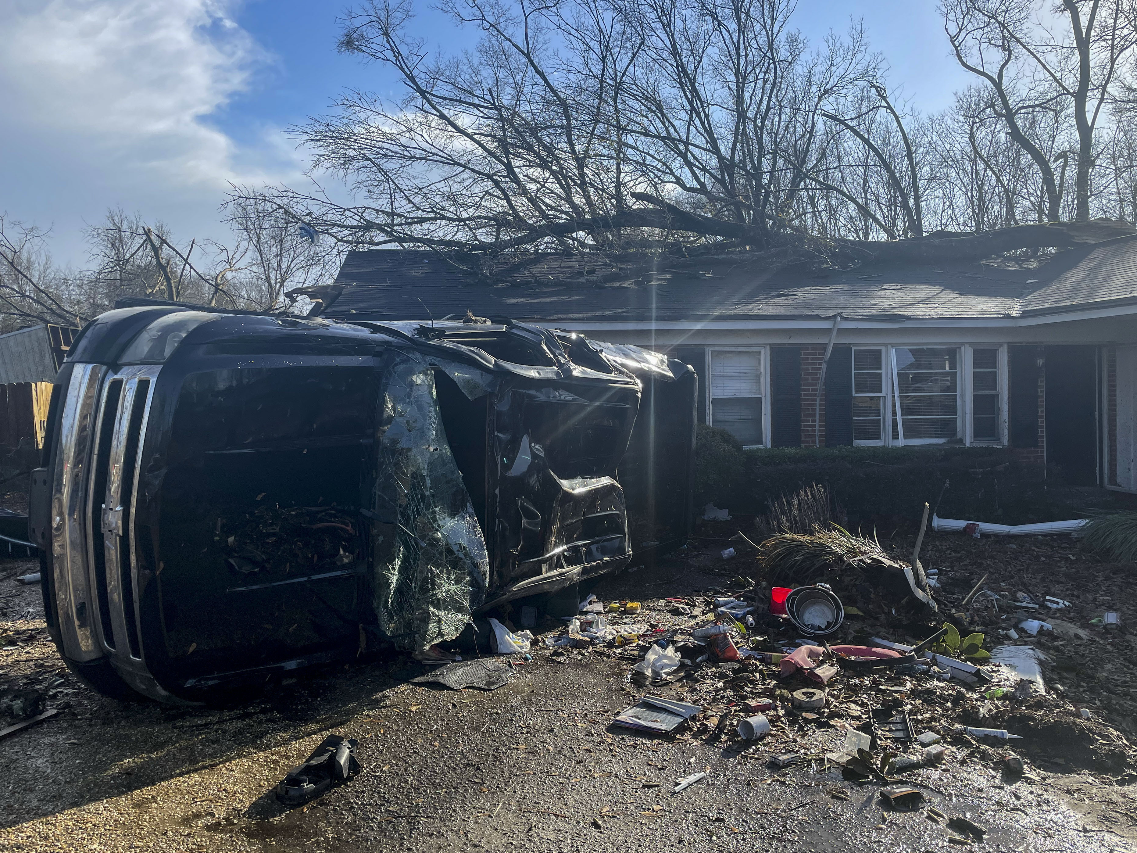 A damaged vehicle lies in front of a residence, Thursday, Jan. 12, 2023, in Selma, Alabama.  (AP Photo/Butch Dill)