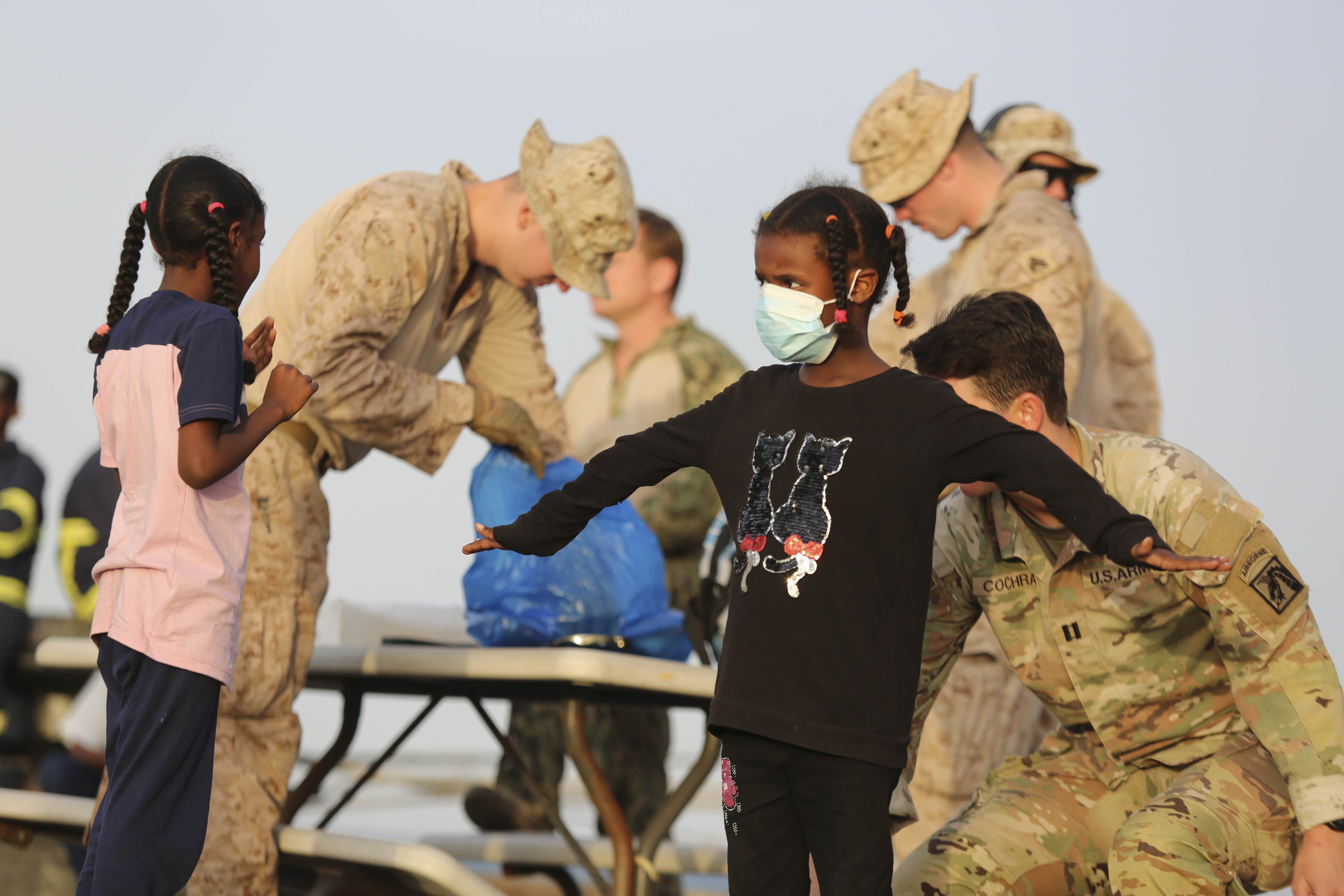 US citizens are frisked by US soldiers before boarding in Port Sudan, Sunday, April 30, 2023. The Sudanese army and a rival paramilitary force have agreed to send representatives to negotiate, the United Nations envoy said Monday, May 1, 2023. to Sudan.  (AP Photo/Smowal Abdalla)