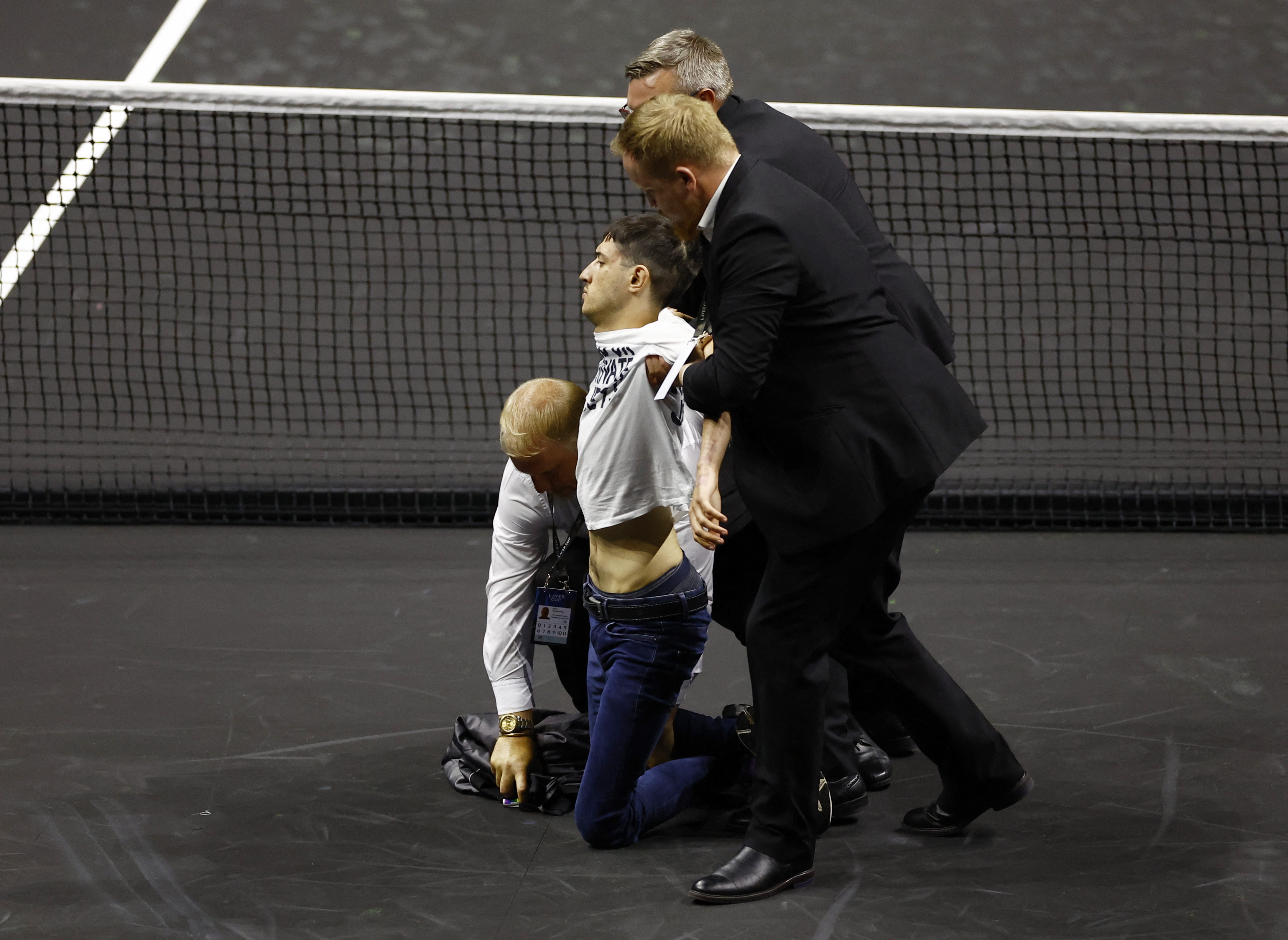 Tennis - Laver Cup - 02 Arena, London, Britain - September 23, 2022   A protester is removed from the court during the match between Team Europe's Stefanos Tsitsipas and Team World's Diego Schwartzman Action Images via Reuters/Andrew Boyers