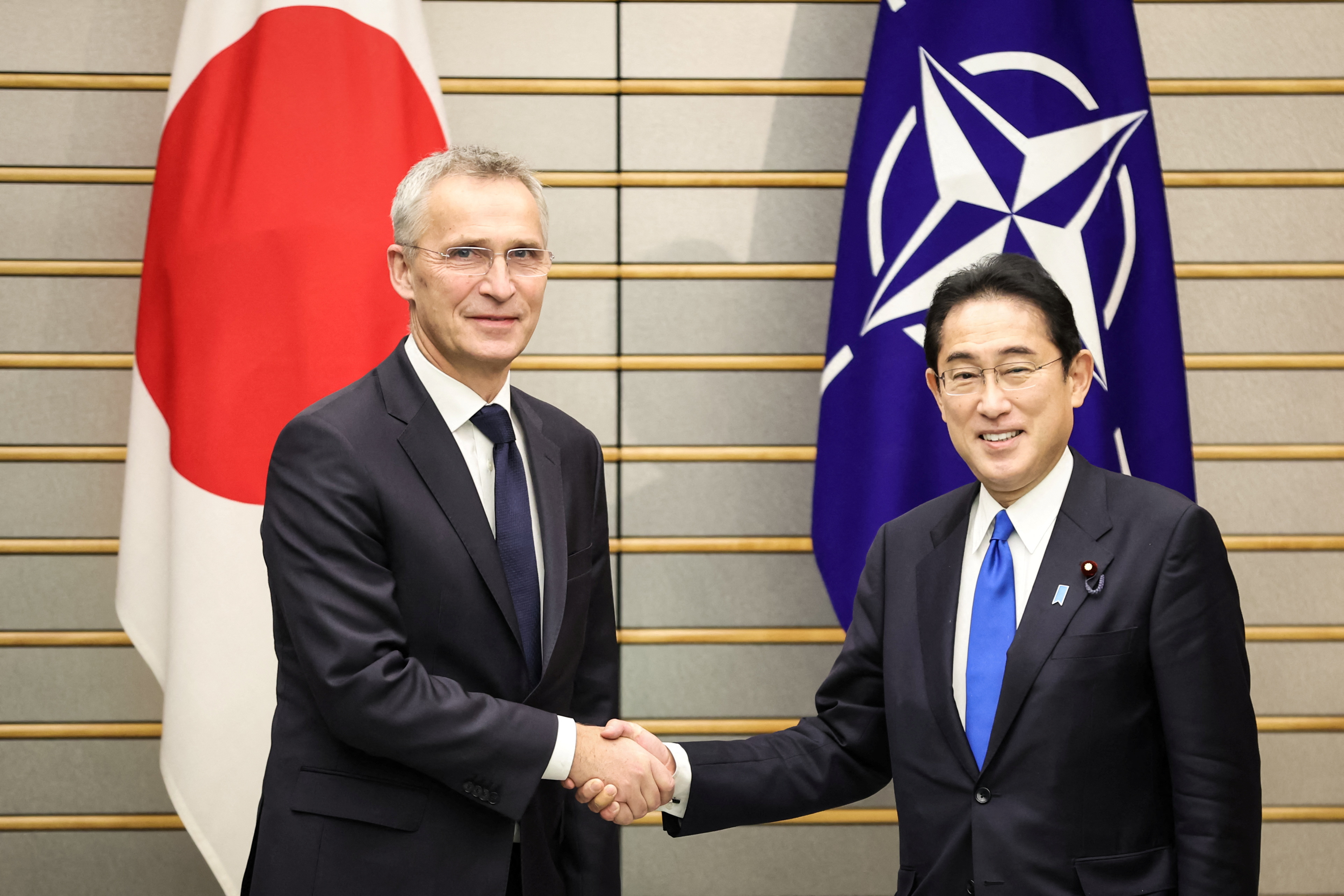 TOKYO, JAPAN - JANUARY 31: NATO Secretary-General Jens Stoltenberg shakes hands with Japan's Prime Minister Fumio Kishida on January 31, 2023 in Tokyo, Japan. Takashi Aoyama/Pool via REUTERS