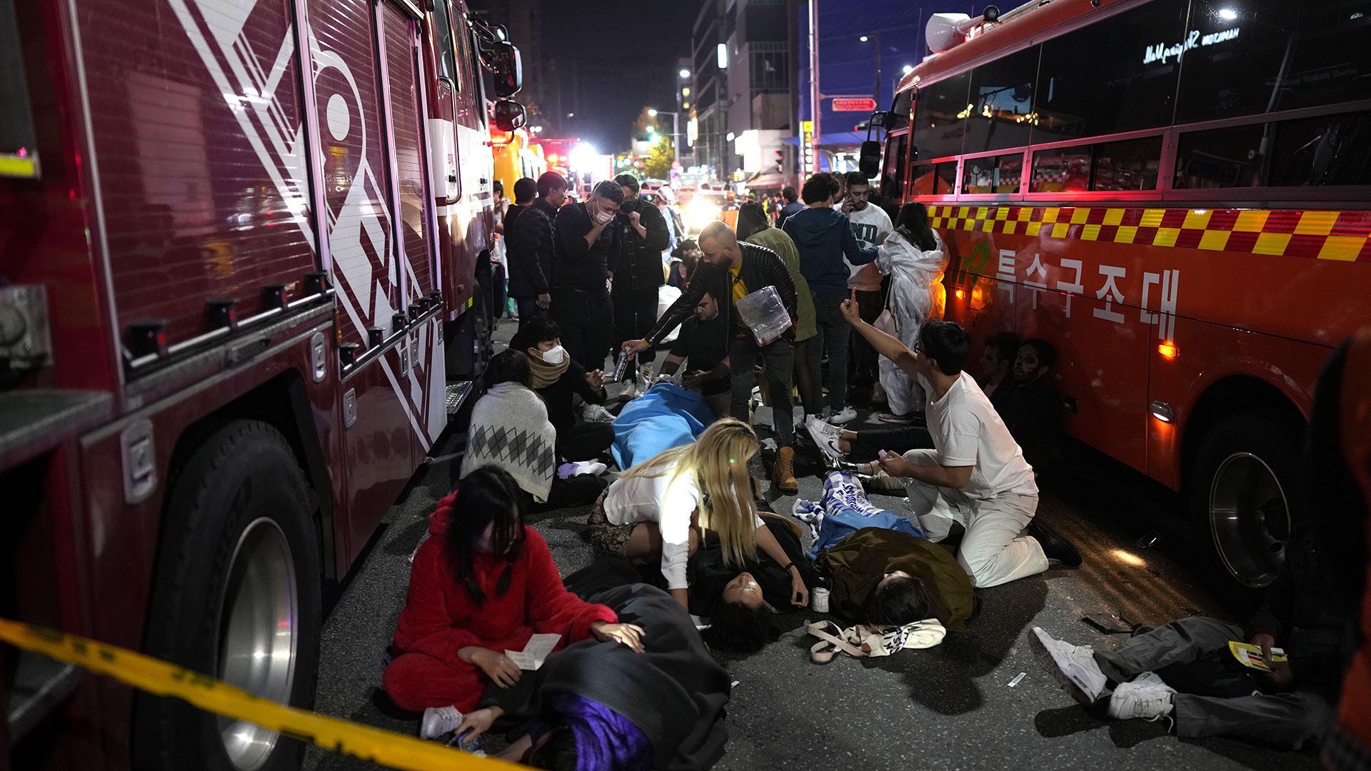 Firefighters attend to victims lying in the streets