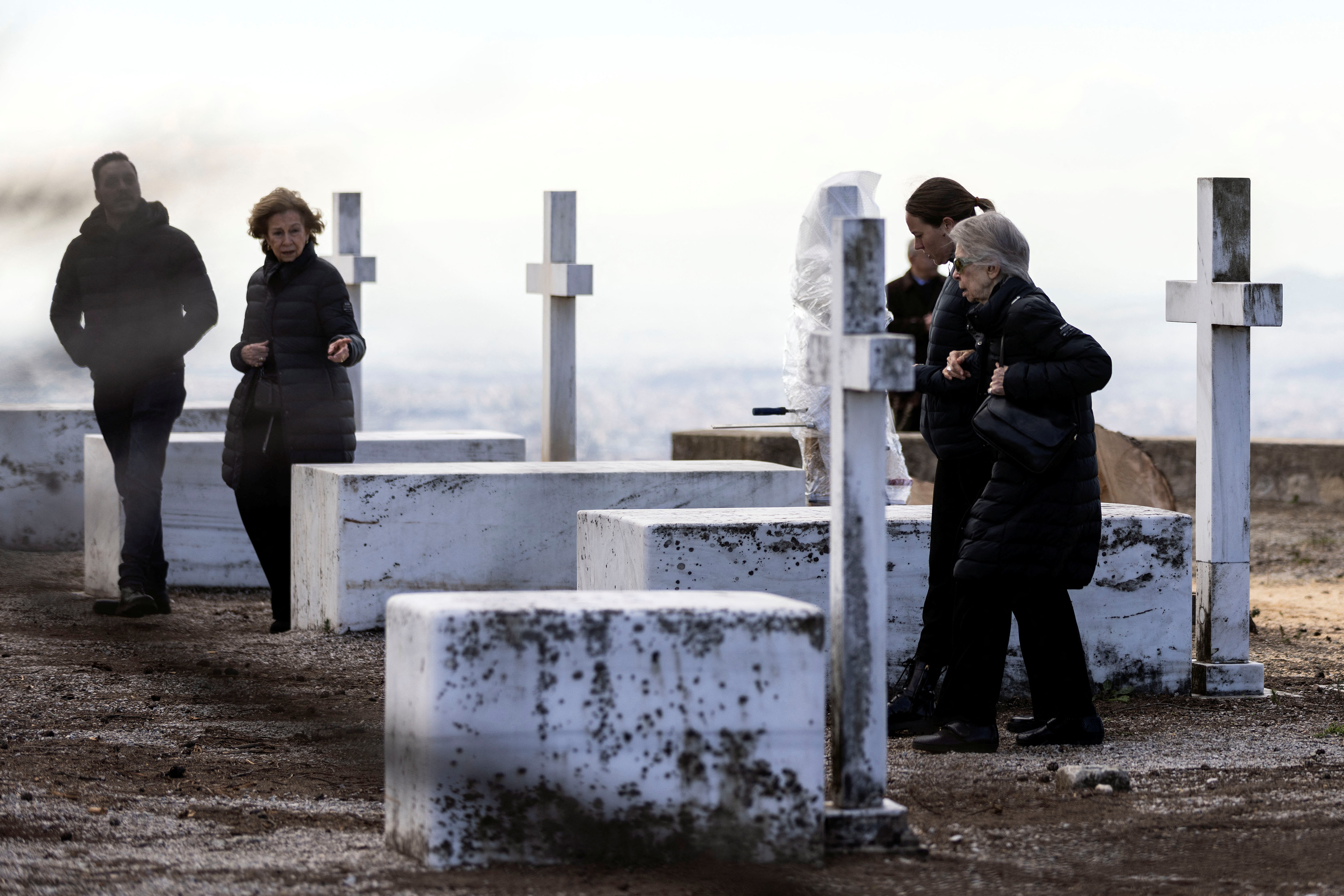 Former Queen of Spain Sofia and former Princess of Greece Irene, sisters of the late former King of Greece Constantine II, walk among the graves of members of the former Greek royal family, on the property of the summer palace where Constantine II will be buried .  REUTERS/Stelios Misinas