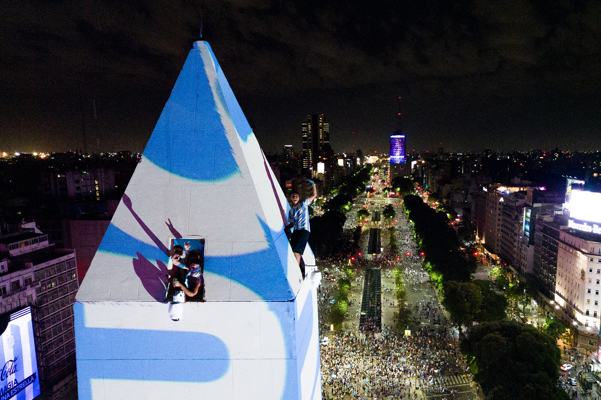 In this aerial view, fans of Argentina celebrate on top of the Obelisk after winning the Qatar 2022 World Cup against France in Buenos Aires on December 18, 2022. (Photo by TOMAS CUESTA / AFP)