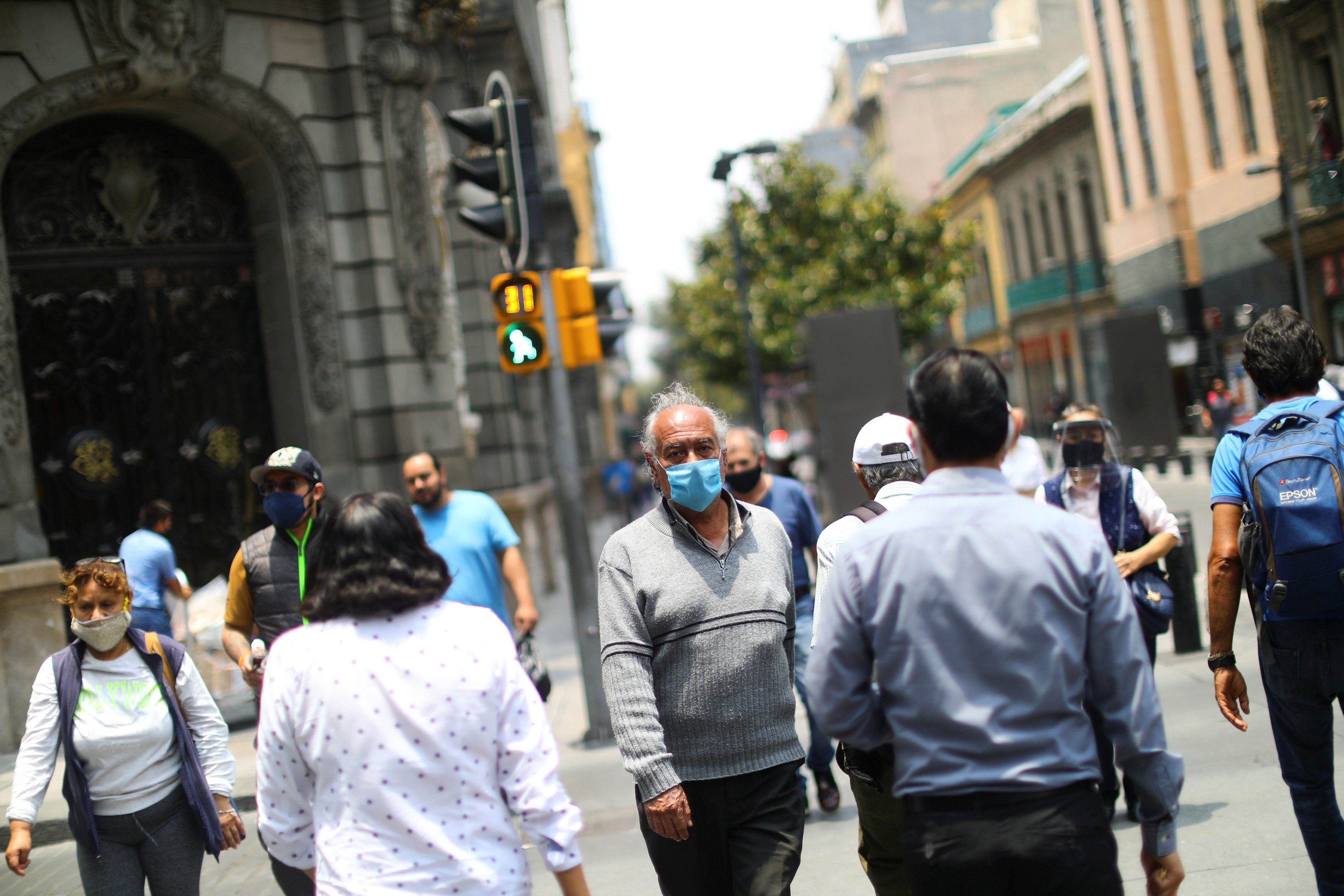 People walk on a street during the start of gradual reopening of commercial activities in downtown Mexico City, as the coronavirus disease (COVID-19) outbreak continues, Mexico June 30, 2020. REUTERS/Edgard Garrido