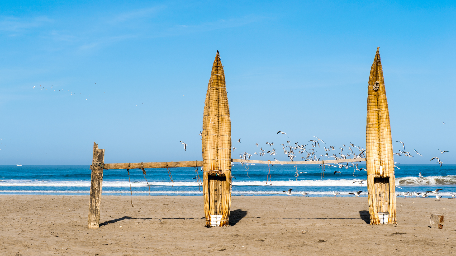 Traditional Peruvian small Reed Boats (Caballitos de Totora), straw boats still used by local fishermens in Peru