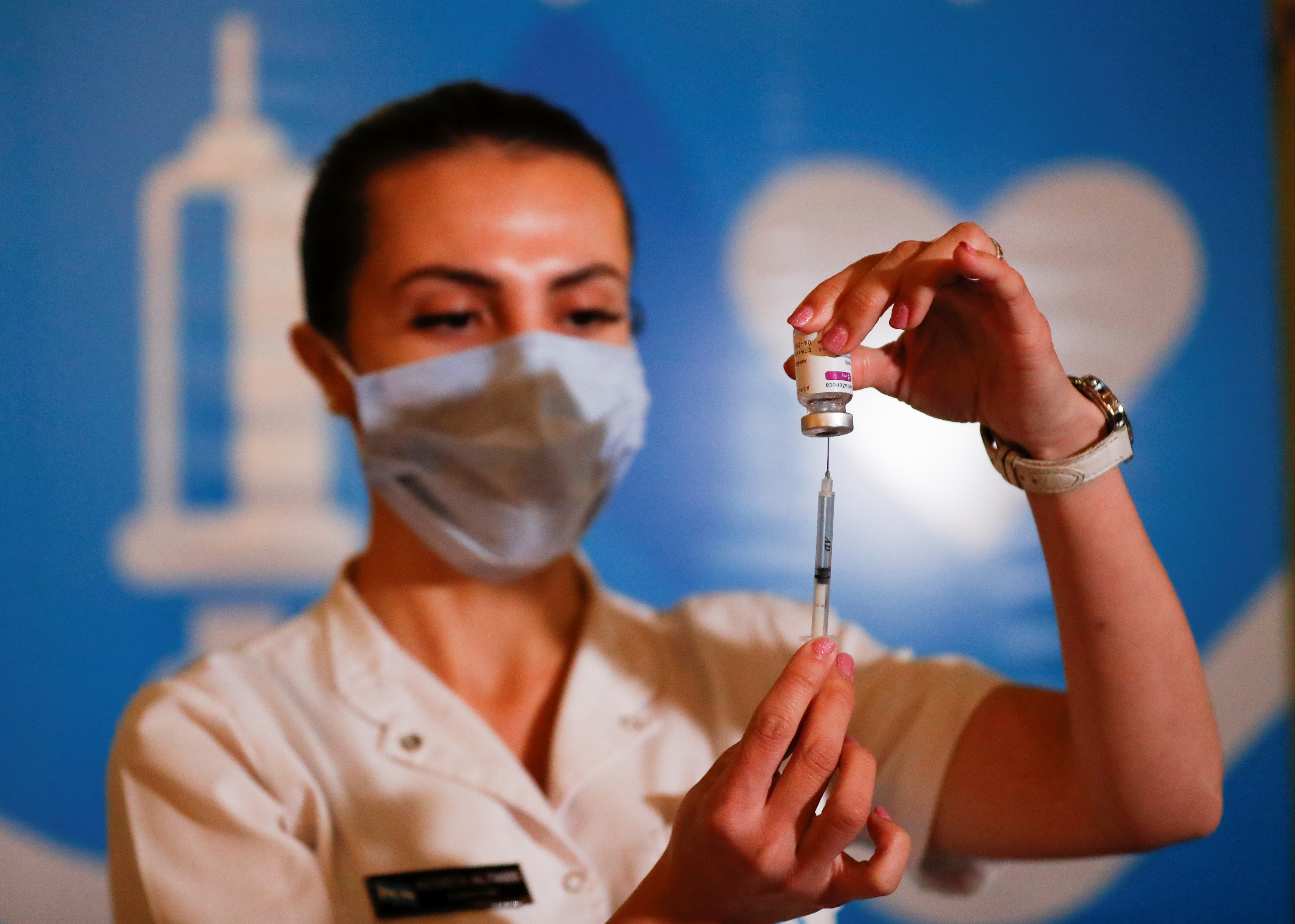 A member of the Armed Forces prepares a dose of the AstraZeneca coronavirus disease (COVID-19) vaccine obtained under the COVAX scheme, at the CCK Cultural Centre (Centro Cultural Kirchner), in Buenos Aires, Argentina June 15, 2021. REUTERS/Agustin Marcarian