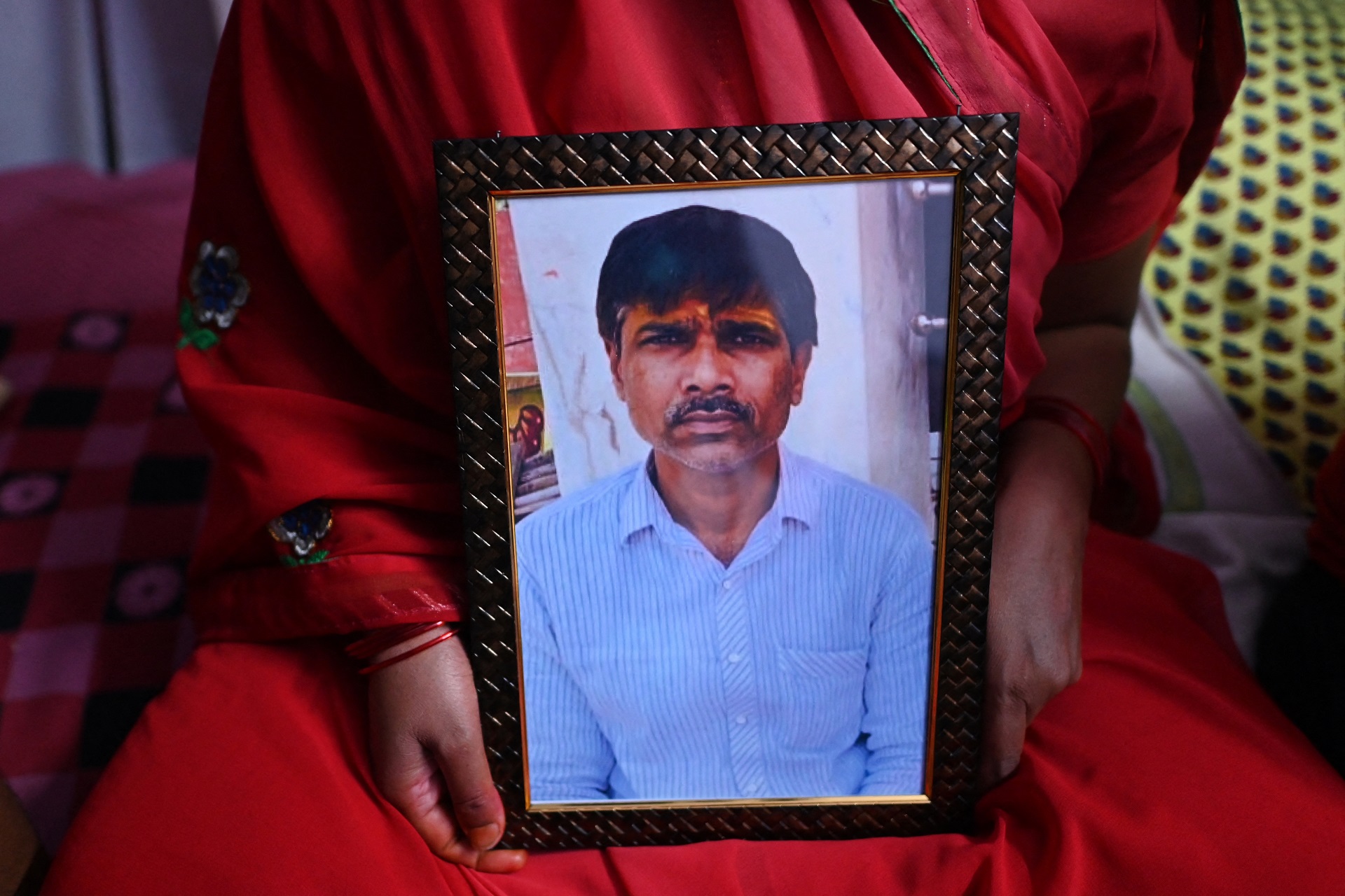 Jashoda Sahu Teli sostiene una foto de su esposo, Kanhaiya Lal, aesinado esta semana (AFP)