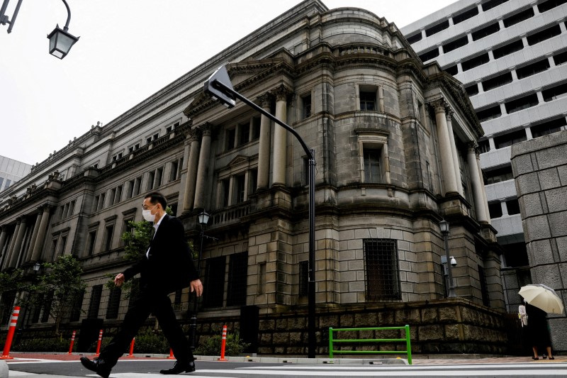 FILE PHOTO.  A man walks past the Bank of Japan headquarters in Tokyo, Japan.  May 22, 2020. REUTERS/Kim Kyung-hoon