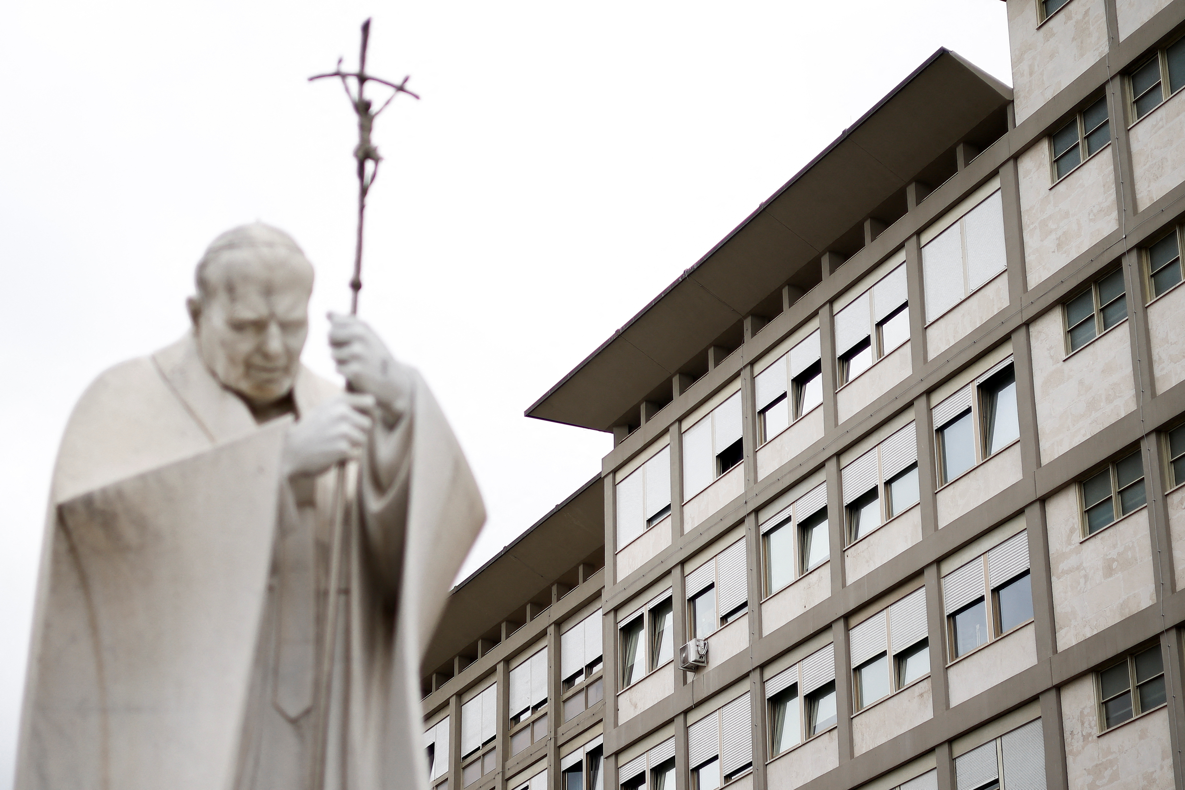 A statue of former Pope John Paul II is seen in the courtyard of the Gemelli Hospital, where Pope Francis is hospitalised for a respiratory infection, in Rome, Italy March 31, 2023. REUTERS/Guglielmo Mangiapane