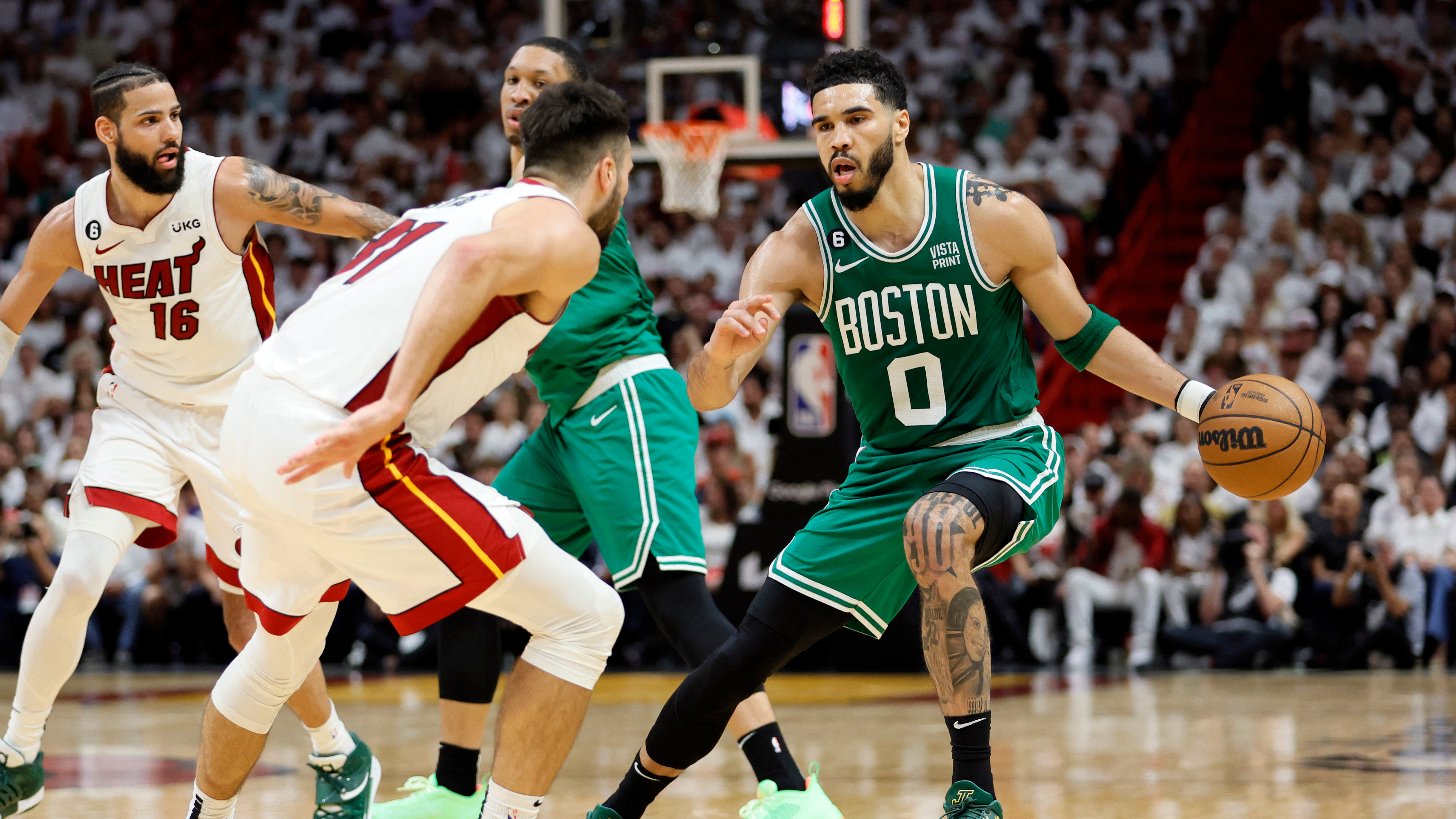 May 23, 2023; Miami, Florida, USA; Boston Celtics forward Jayson Tatum (0) controls the ball against Miami Heat guard Max Strus (31) in the third quarter during game four of the Eastern Conference Finals for the 2023 NBA playoffs at Kaseya Center. Mandatory Credit: Sam Navarro-USA TODAY Sports