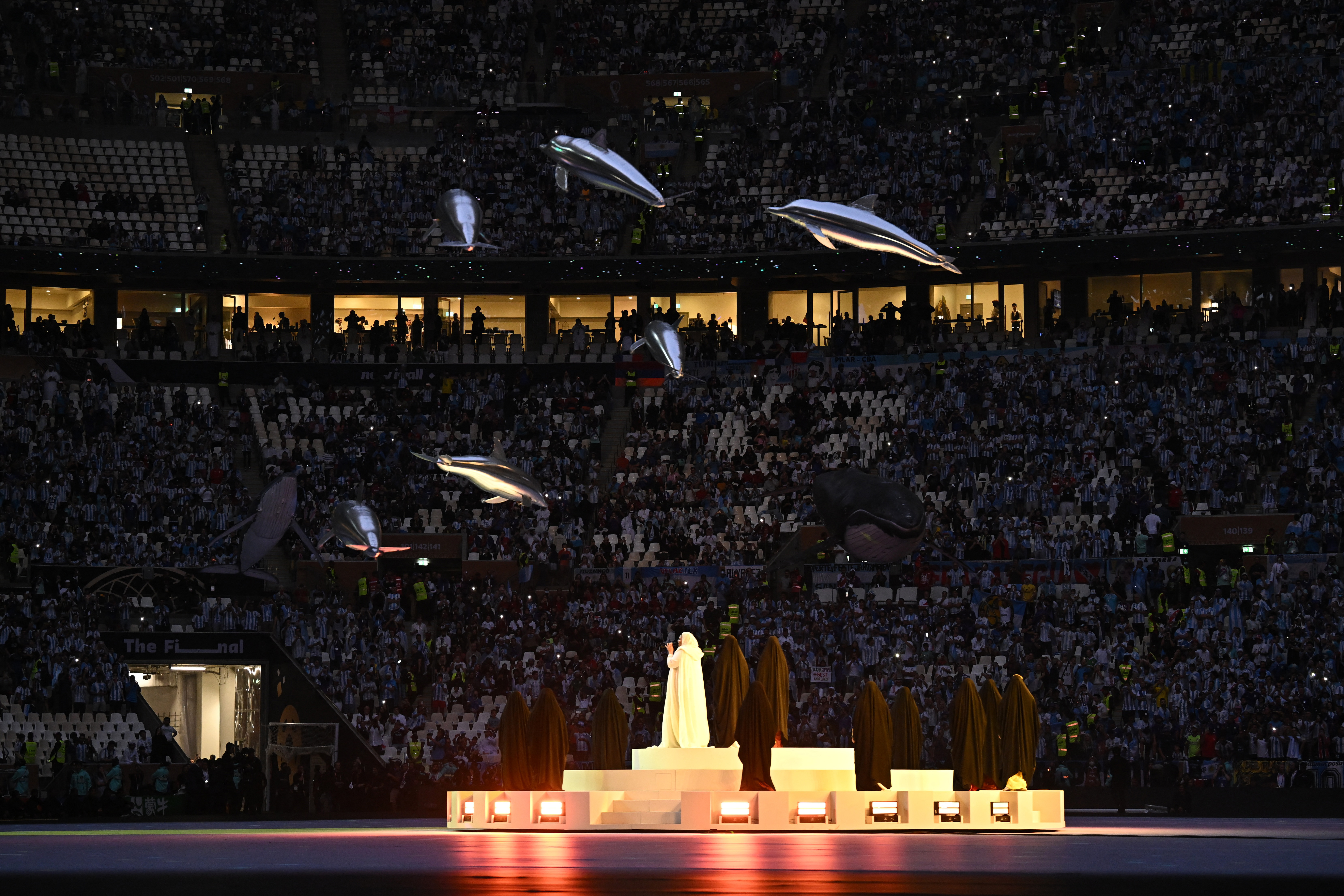 Football Football - FIFA World Cup Qatar 2022 - Final - Argentina v France - Lusail Stadium, Lusail, Qatar - December 18, 2022 A woman performs at the closing ceremony before the match REUTERS/Dylan Martinez