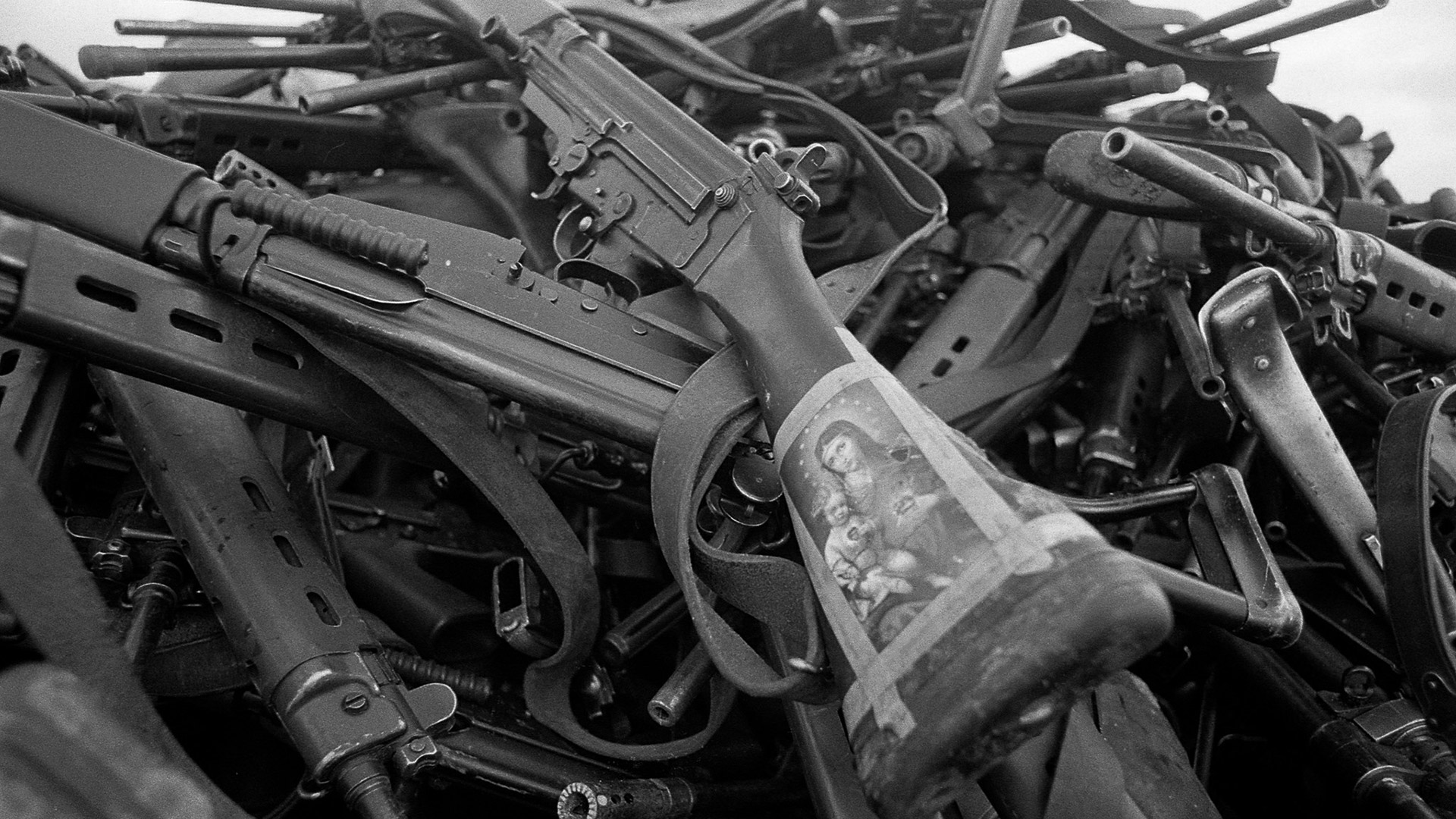 Una estampita de la Virgen María y el Niño Jesús en un fusil argentino, arrojado a una pila de armamento entregado por nuestros soldados luego del cese de fuego el 14 de junio de 1982 (Foto: Paul Haley, Soldier Magazine, IWM)