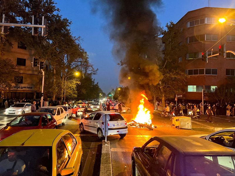 FILE PHOTO: A police motorcycle burns during a protest over the death of Mahsa Amini, in Tehran, Iran, September 19, 2022. WANA (West Asia News Agency) via REUTERS