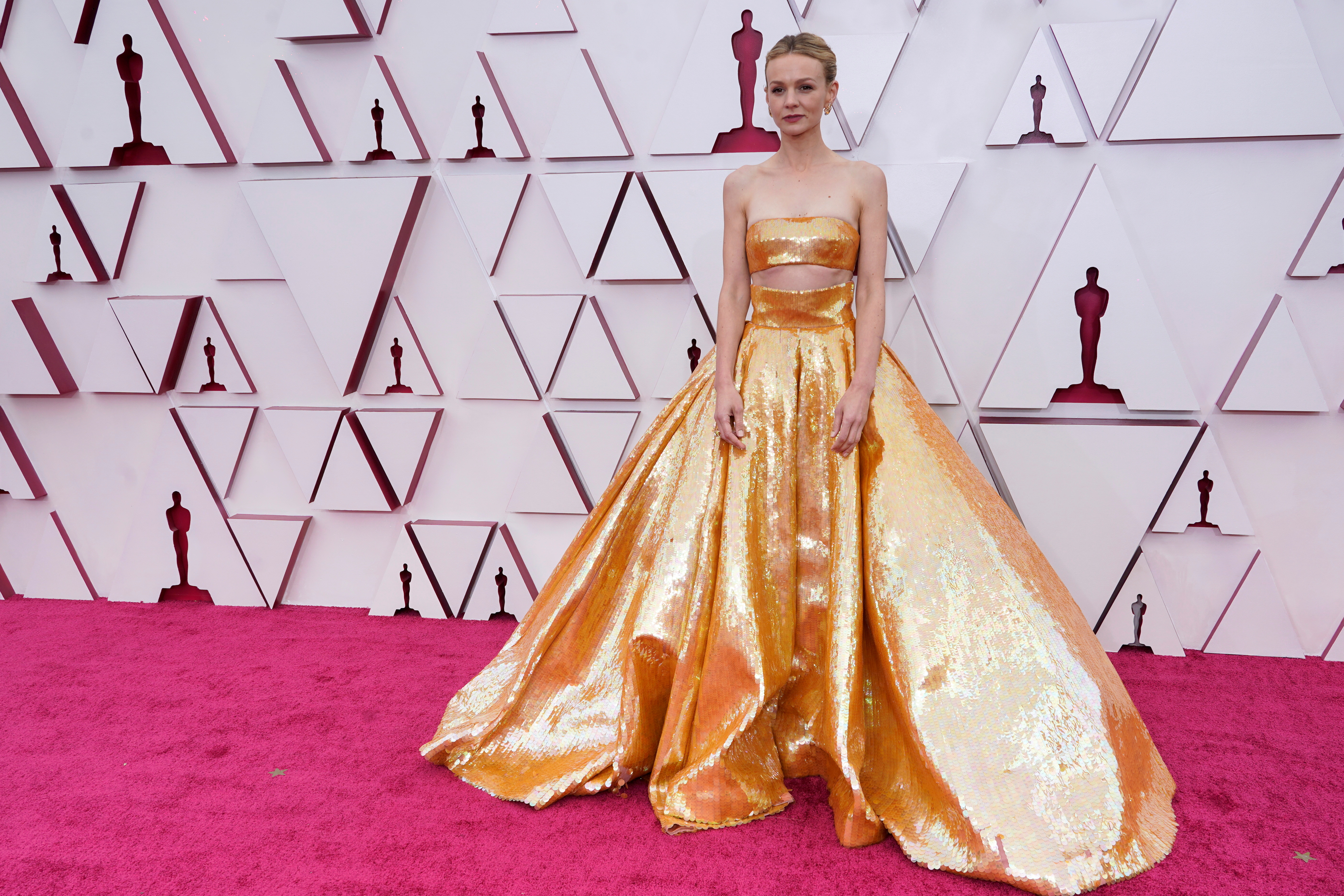 Por Valentino y joyas de Cartier. Carey Mulligan eligió un conjunto de dos piezas de top y falda XL de paillettes dorados que impactó en la alfombra roja de los Oscars 