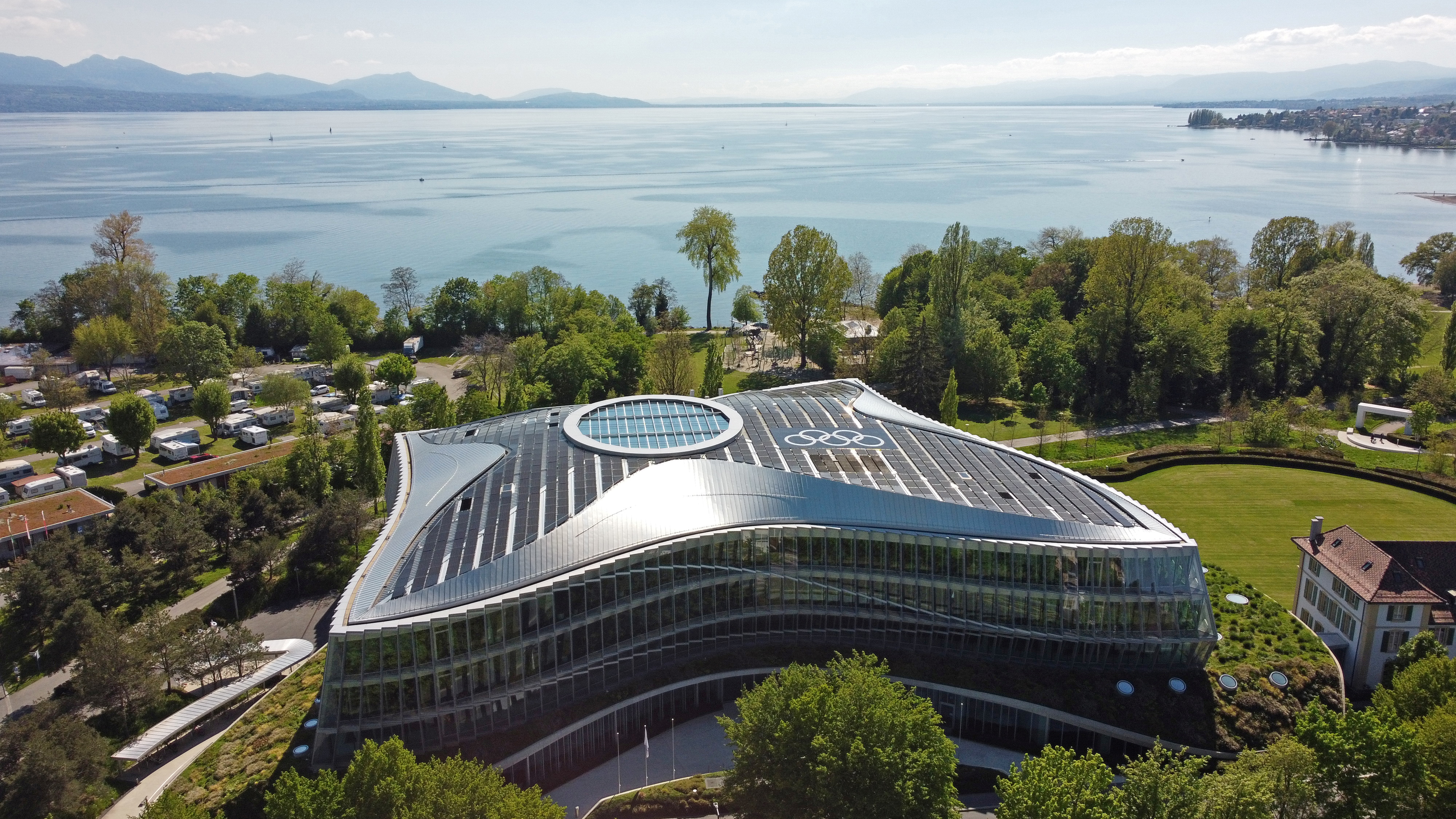 The Olympic rings are pictured among solar panels on top of the International Olympic Committee (IOC) headquarters in Lausanne, Switzerland, May 3, 2021. Picture taken with a drone. REUTERS/Denis Balibouse