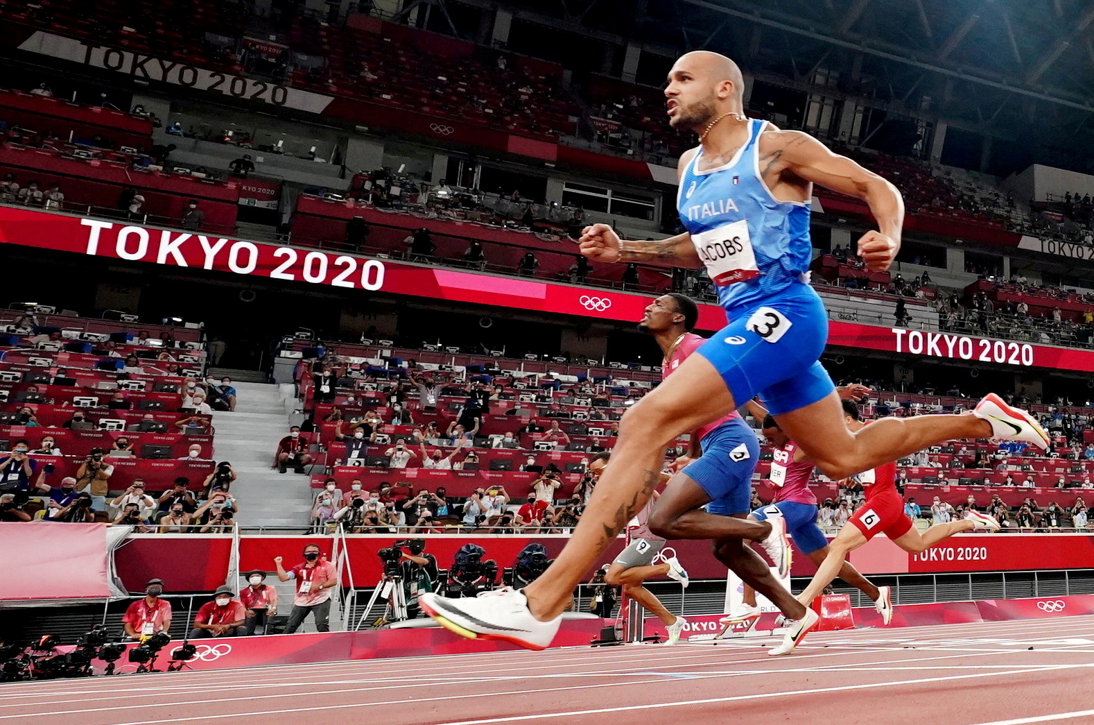 Tokyo 2020 Olympics - Athletics - Men's 100m - Final - OLS - Olympic Stadium, Tokyo, Japan - August 1, 2021. Lamont Marcell Jacobs of Italy crosses the finish line and wins gold REUTERS/Fabrizio Bensch/File Photo     TPX IMAGES OF THE DAY SEARCH "POY SPORTS" FOR THIS STORY. SEARCH "REUTERS POY" FOR ALL BEST OF 2021 PACKAGES