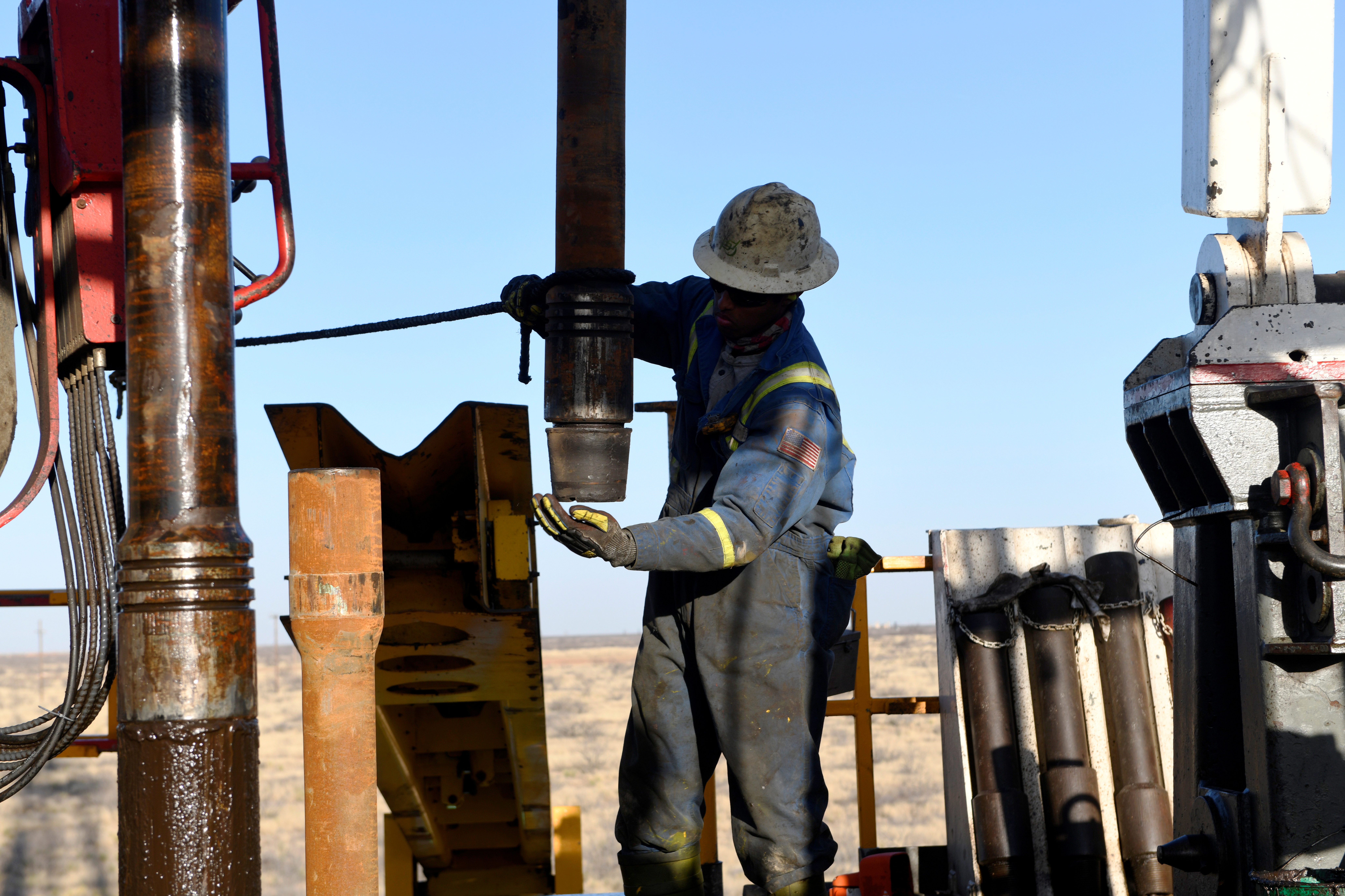 Un trabajador petrolero quita una tapa de rosca de un trozo de tubería de perforación en un pozo propiedad de Elevation Resources cerca de Midland, Texas (REUTERS / Nick Oxford / Foto de archivo)