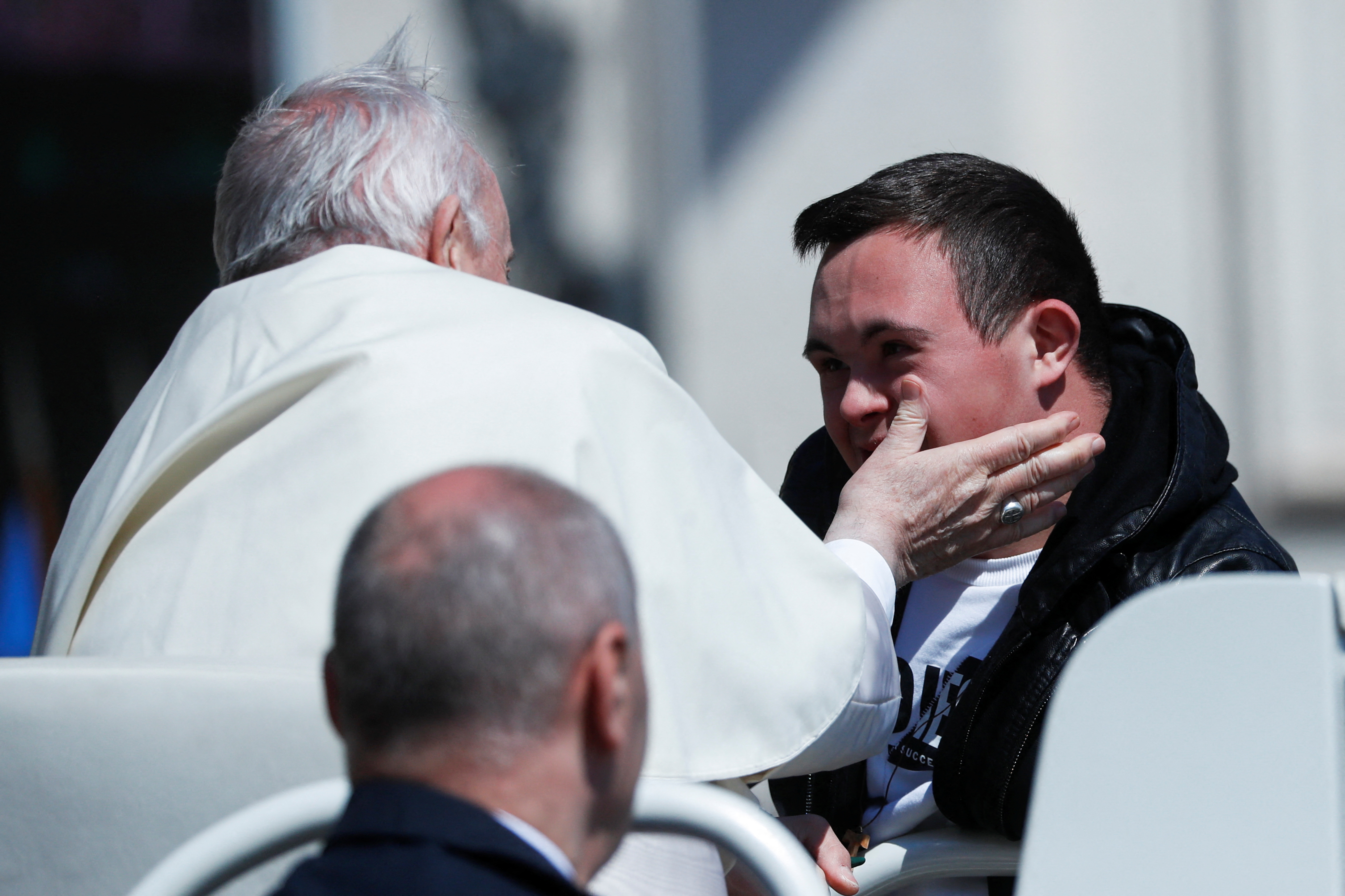 Pope Francis blesses a man with Down syndrome from his Popemobile, after celebrating Easter Mass in St. Peter's Square at the Vatican, April 17, 2022. REUTERS/Yara Nardi