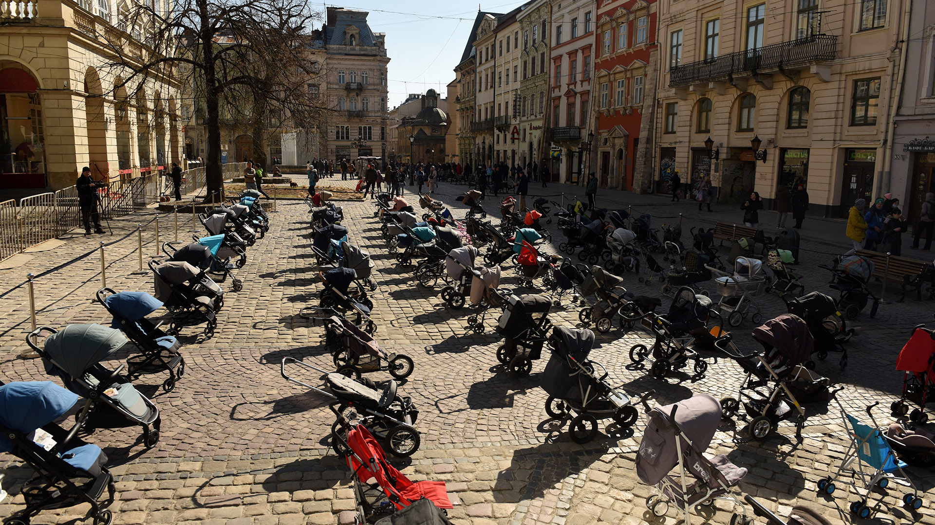In this picture taken on March 18, 2022, 109 empty prams and baby baskets are seen placed outside the Lviv city council during an action to highlight the number of children killed in the ongoing Russia's invasion of Ukraine. (Photo by Yuriy Dyachyshyn / AFP)