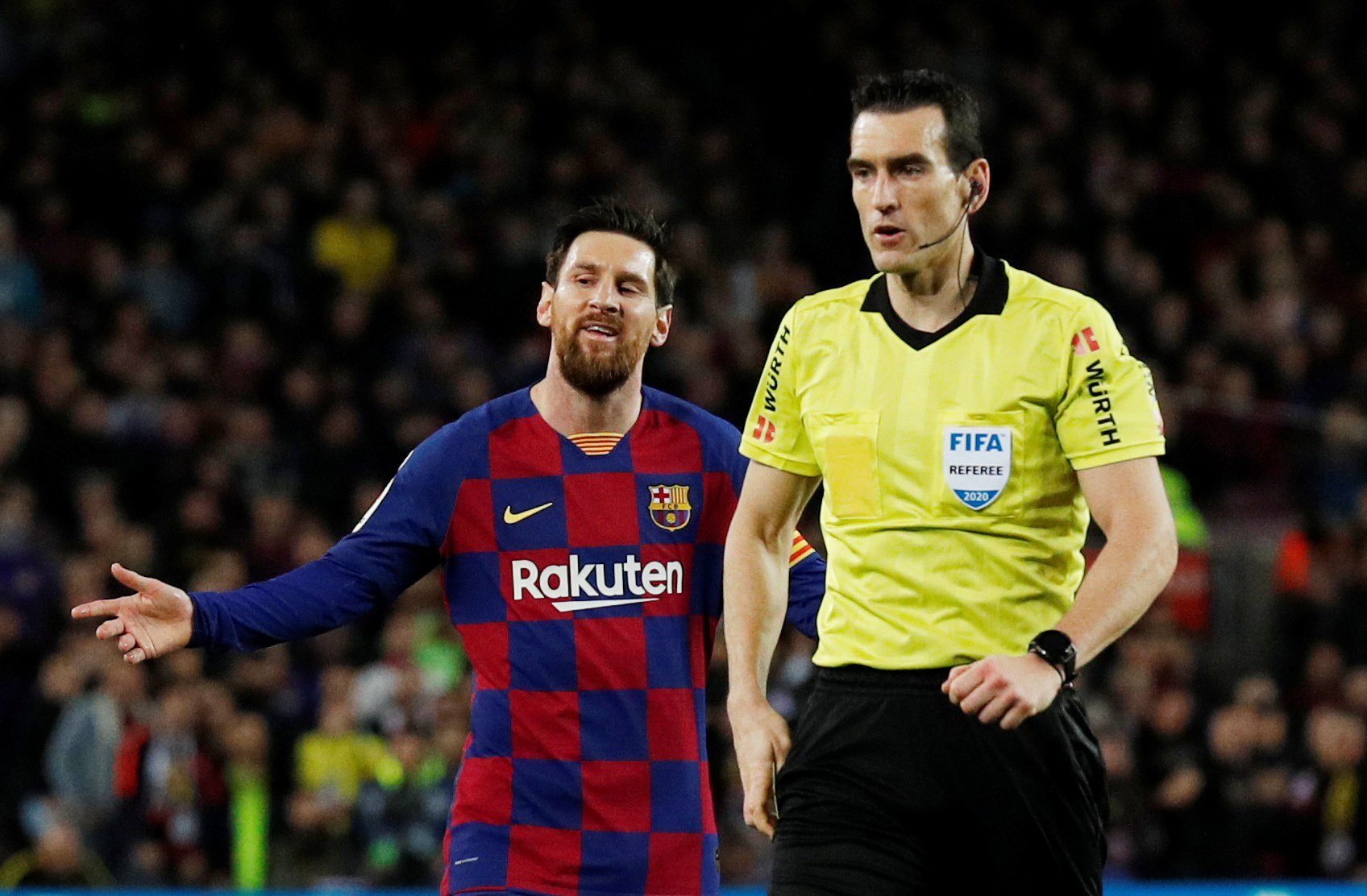 Soccer Football - La Liga Santander - FC Barcelona v Real Sociedad - Camp Nou, Barcelona, Spain - March 7, 2020  Barcelona's Lionel Messi reacts after being shown a yellow card by referee Juan Martinez Munuera  REUTERS/Albert Gea