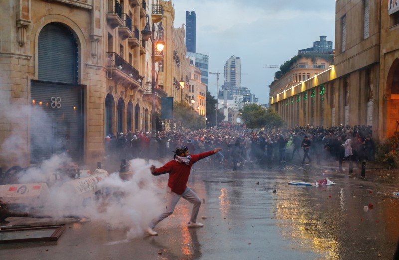 Un manifestante lanza el gas lacrimógeno que había arrojado la policía durante una protesta contra la élite gobernante acusada de conducir al Líbano hacia una crisis económica. REUTERS/Mohamed Azakir