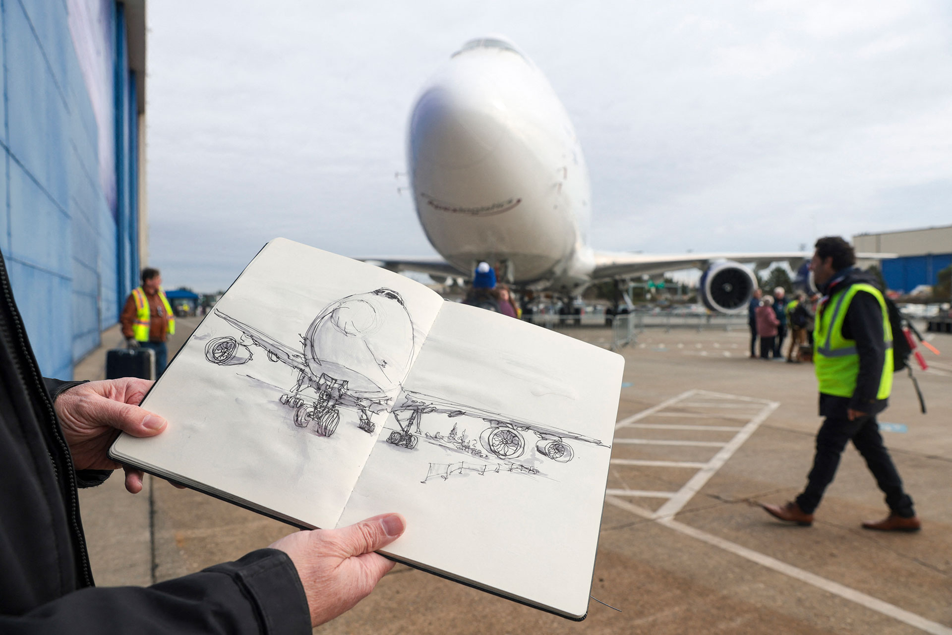 Artist Jeff Barlow of Boeing's creative department displays his sketch of the latest Boeing 747 aircraft at a ceremony to commemorate its delivery, at the Boeing Museum of the Future of Flight in Everett, Wash., on January 31, 2023. Jason Redmond / AFP